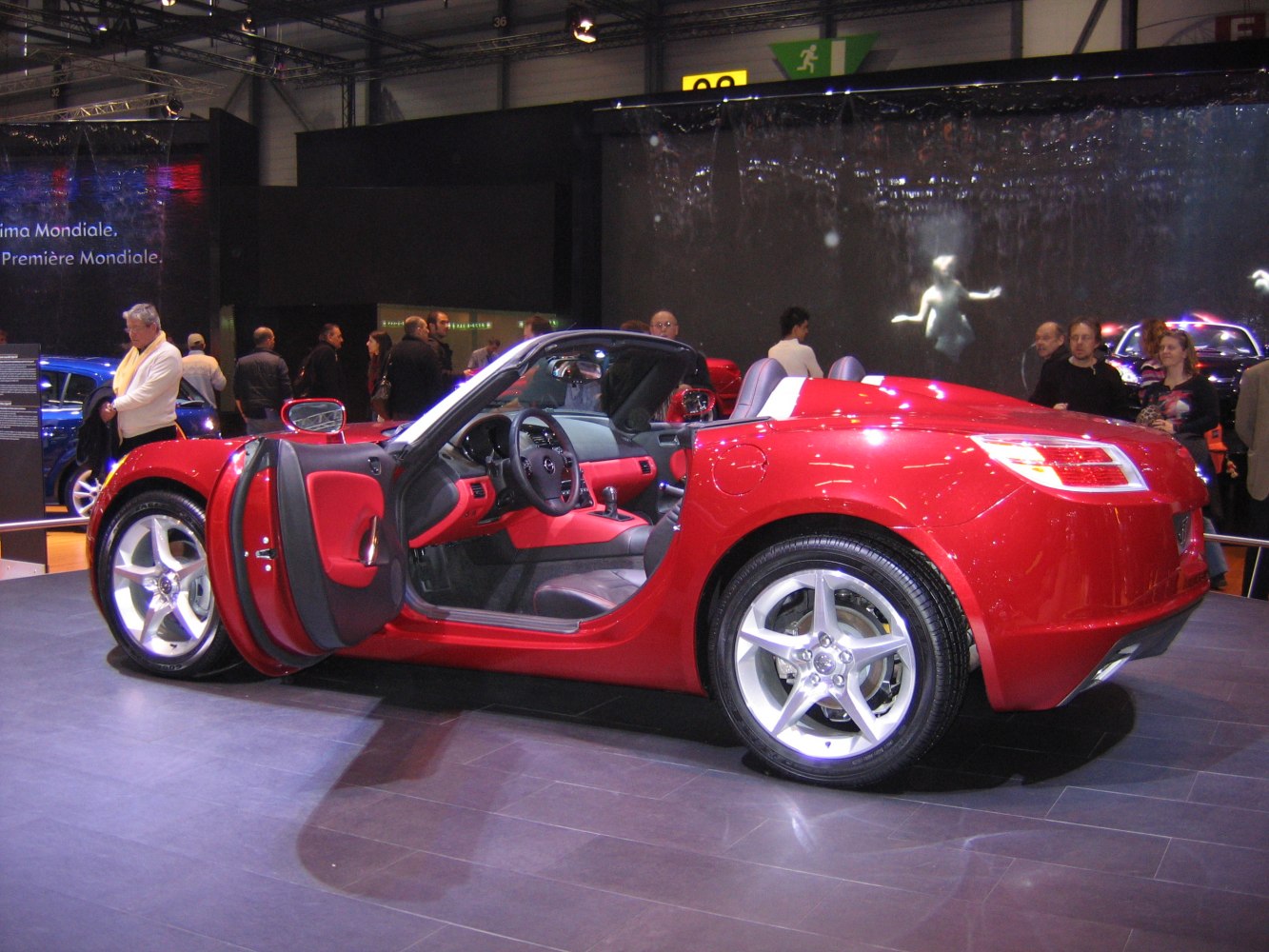 Red convertible with open driver door and leather interior