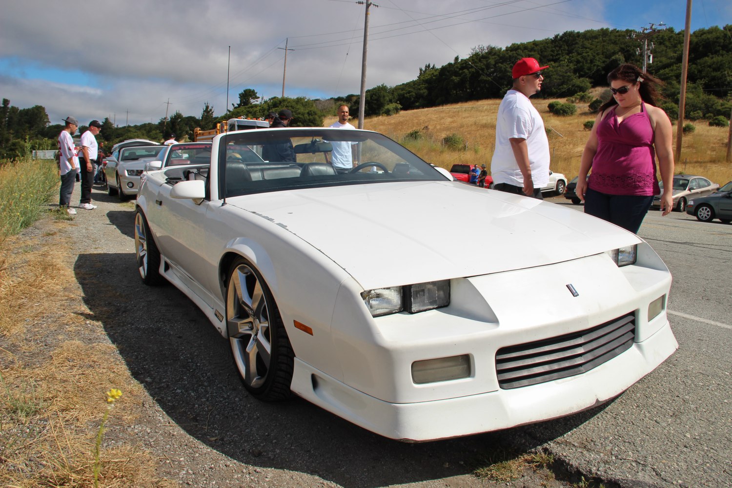 White convertible sports car with aggressive grille and custom alloy wheels