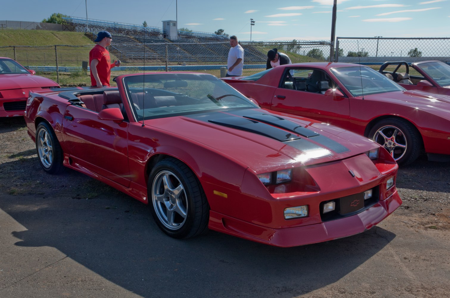 Convertible sports car with black hood stripe and five-spoke wheels