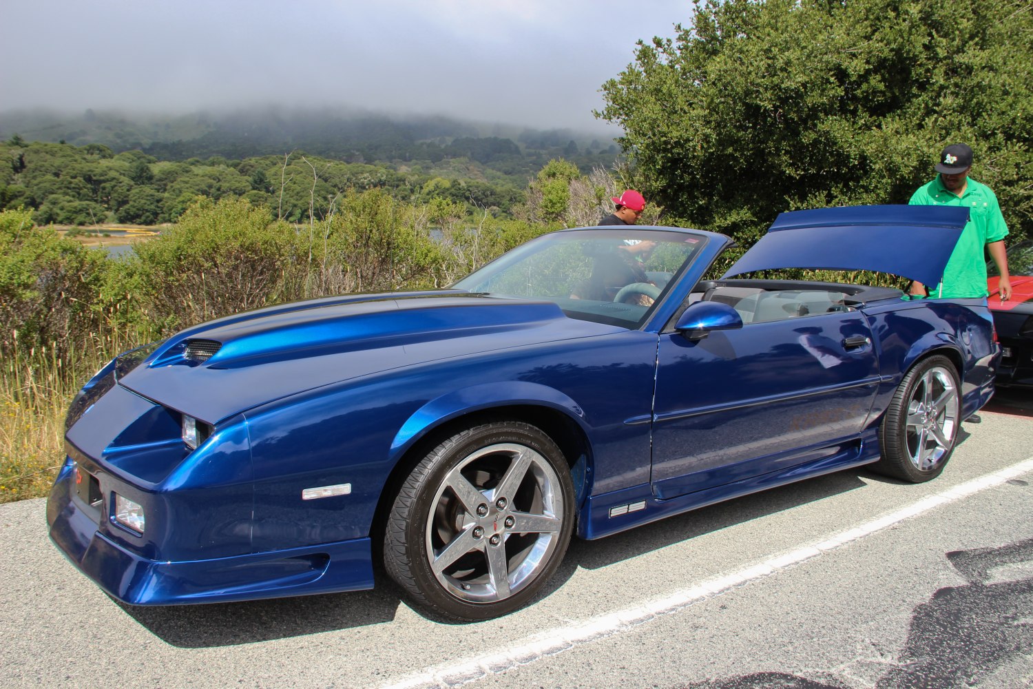 Blue convertible with hood scoop and alloy wheels
