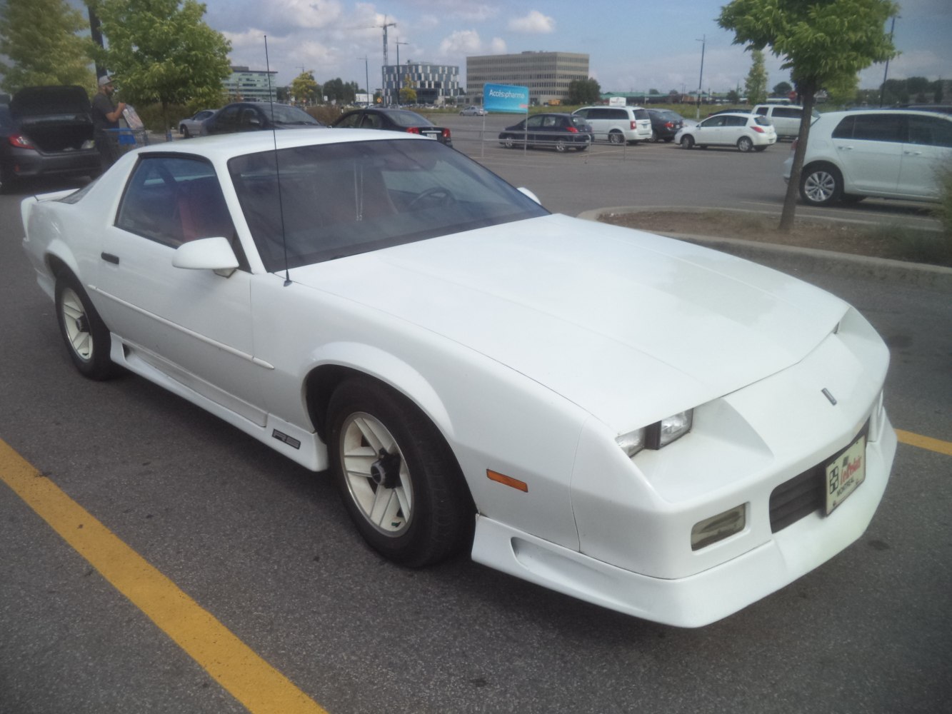White sports coupe with pop-up headlights and aerodynamic design