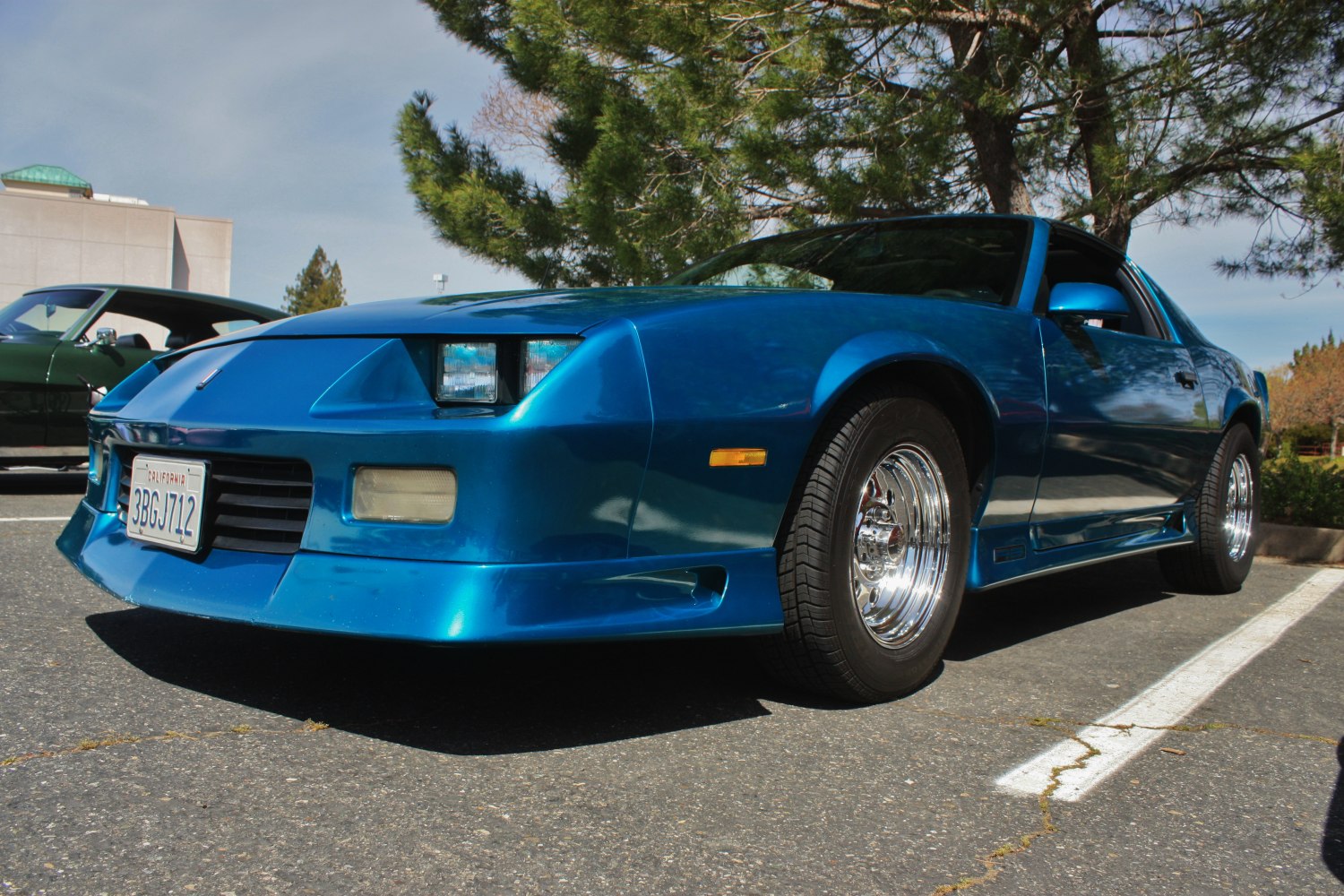 Blue sporty coupe with pop-up headlights and chrome wheels