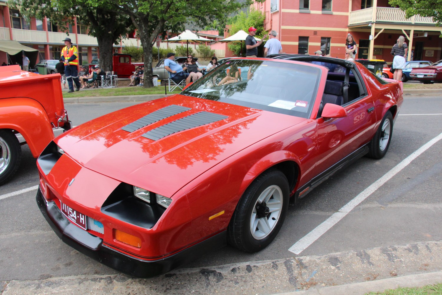 Red 1991 sports coupe with hood vents and T-top roof
