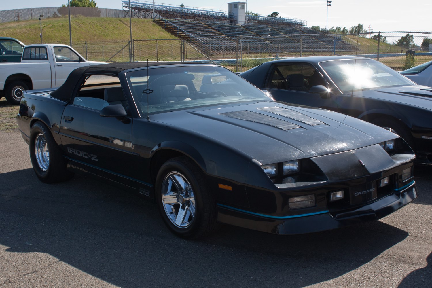 Classic convertible muscle car with distinctive front design and soft top