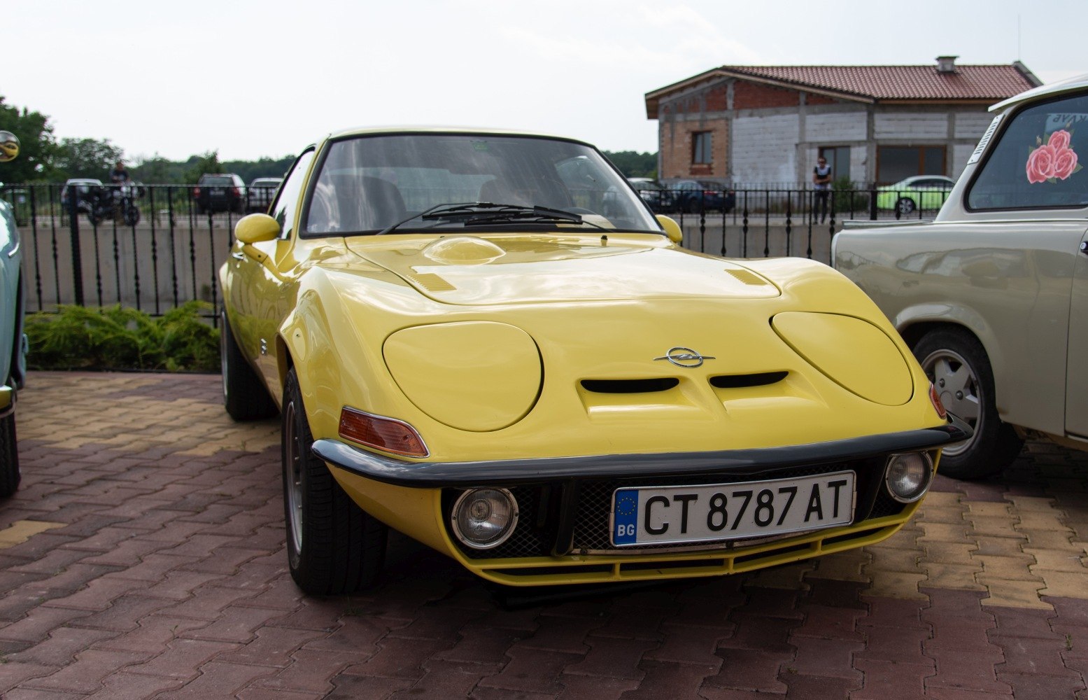 Pop-up headlights and yellow sporty coupe front view