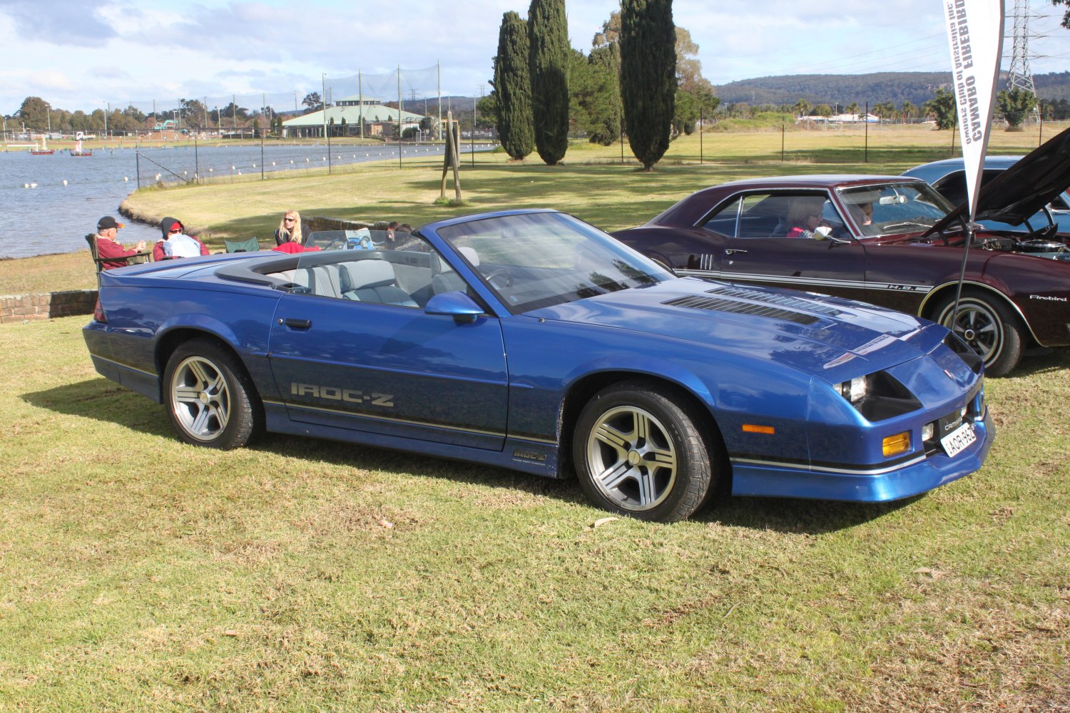 Blue convertible with sporty wheels and classic muscle car design.