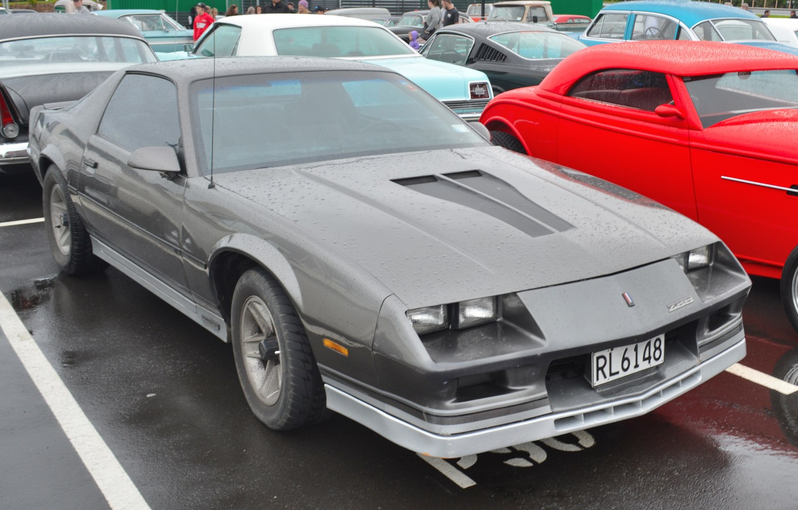Front and side view with distinct hood vents on a 1980s coupe