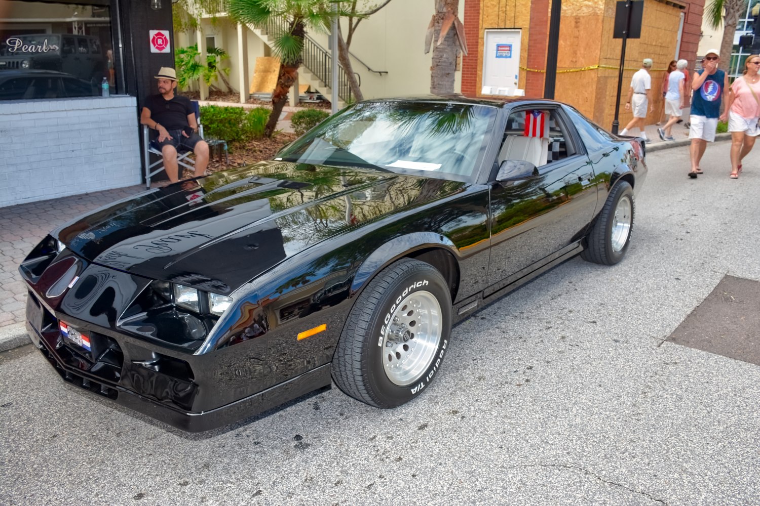 Black muscle car with custom alloy wheels and wide BFGoodrich tires