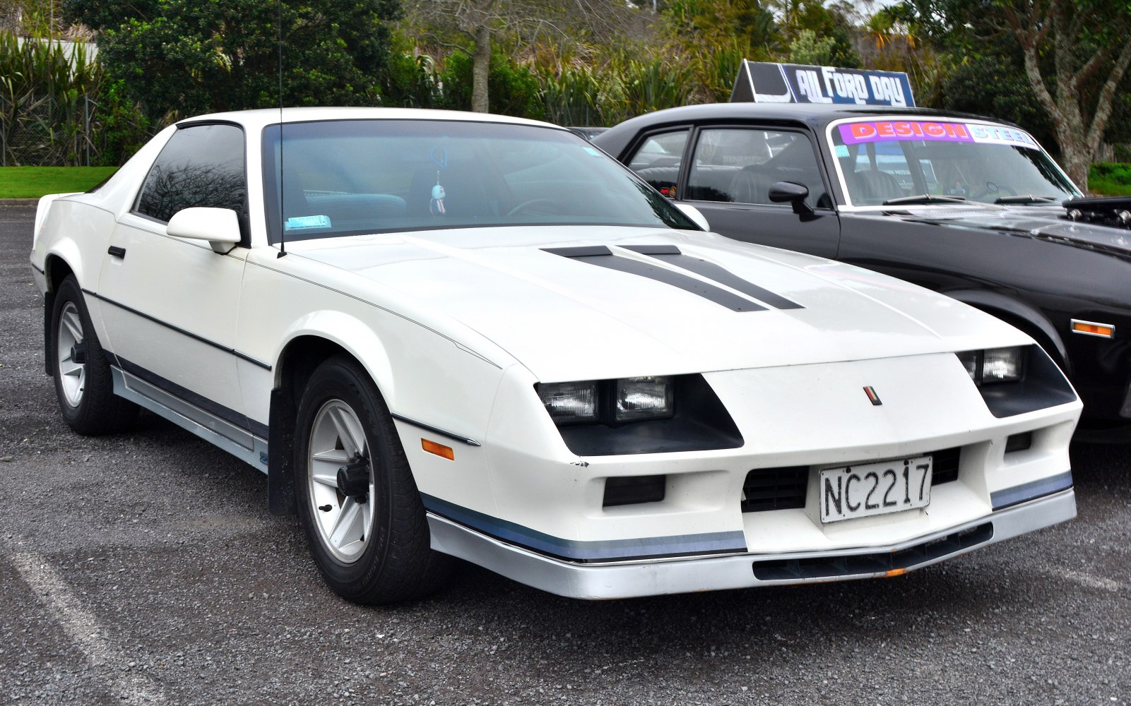 White coupe with hood vents and sporty alloy wheels