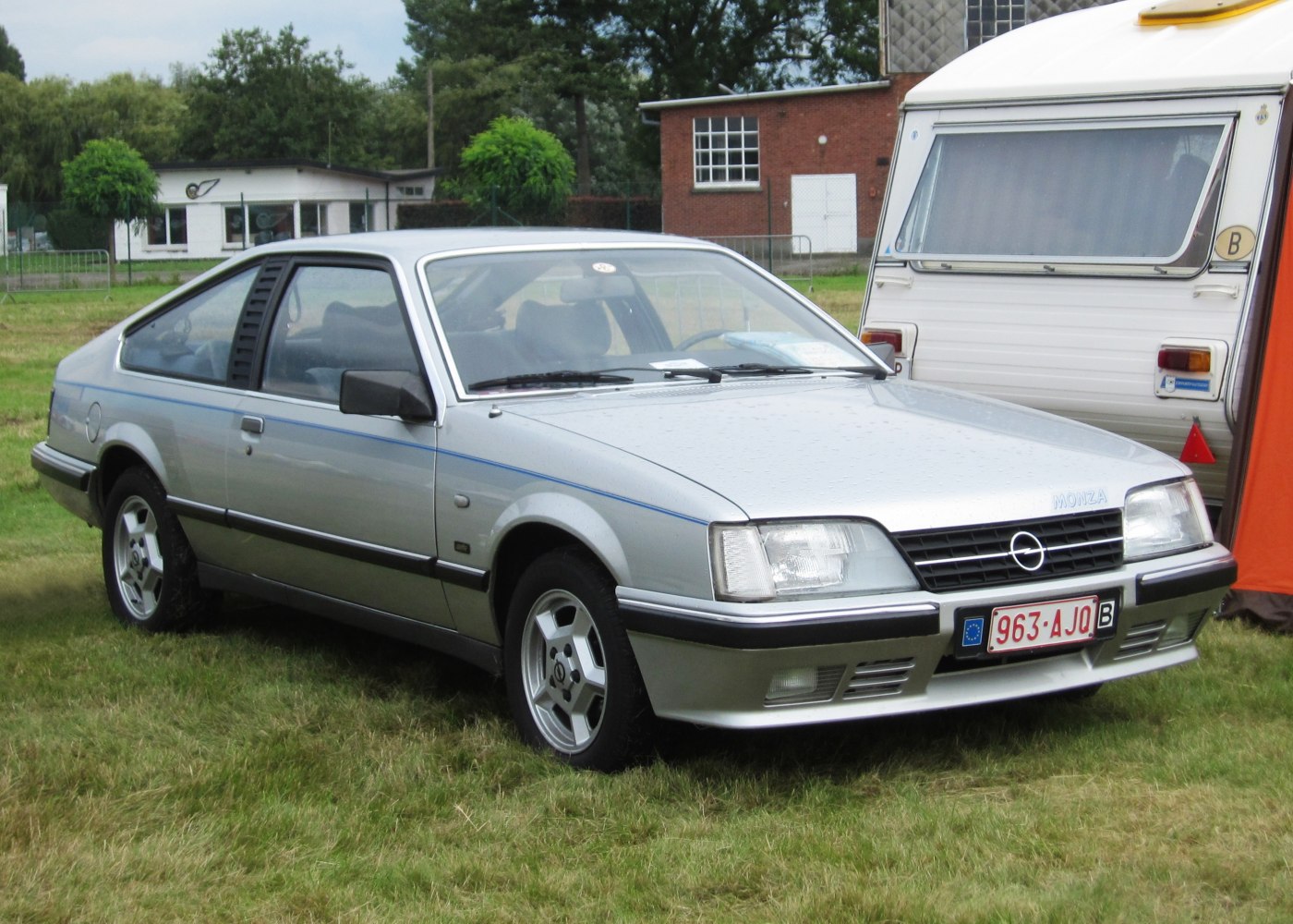 Silver sporty coupe with angular headlights and five-spoke alloy wheels