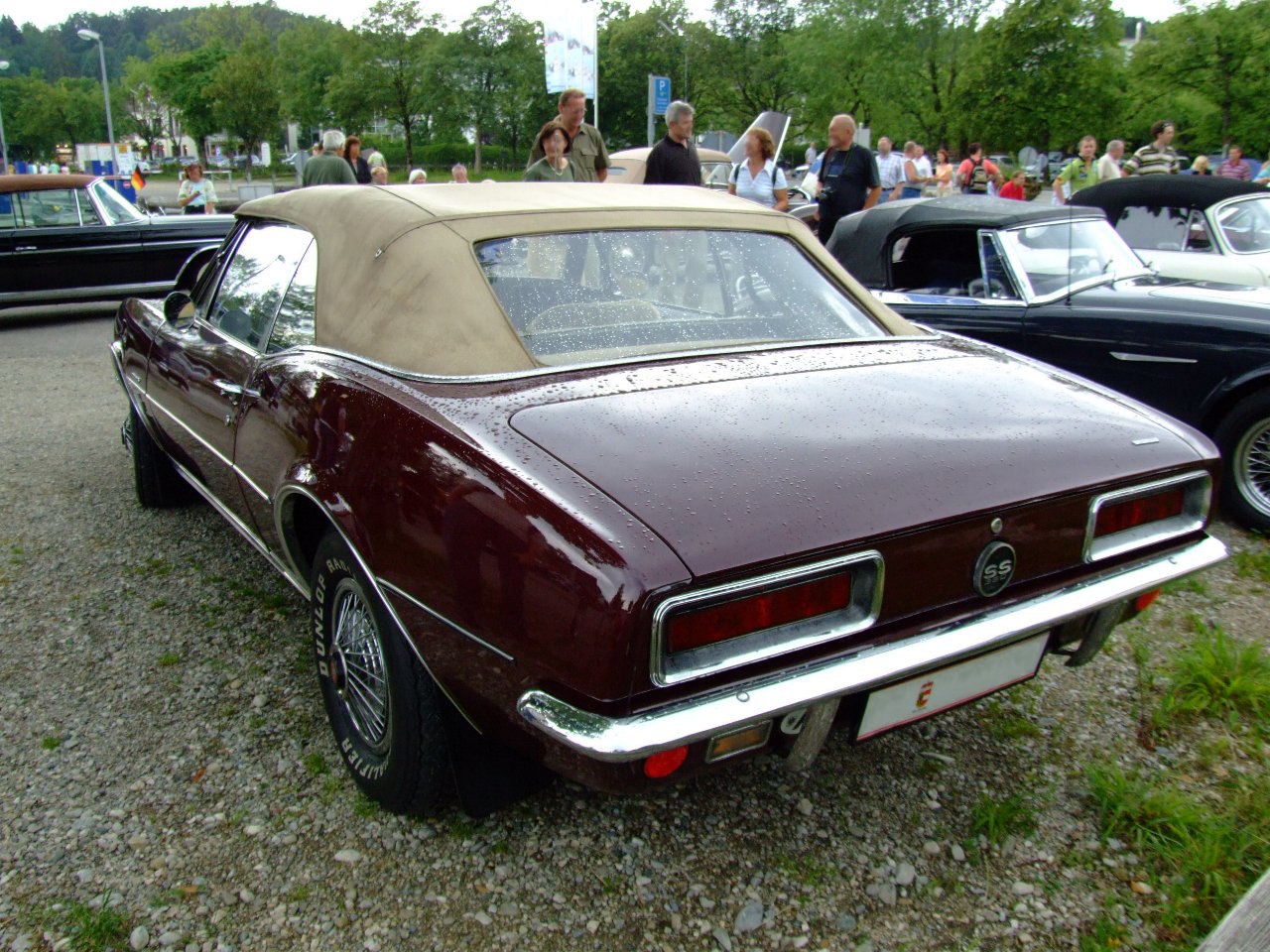 Convertible with beige soft top, rear SS badge, and wire-style wheels