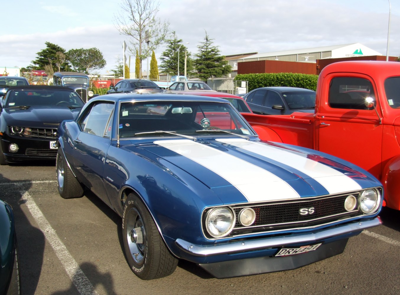 Classic muscle coupe with dual racing stripes and SS badge on front grille
