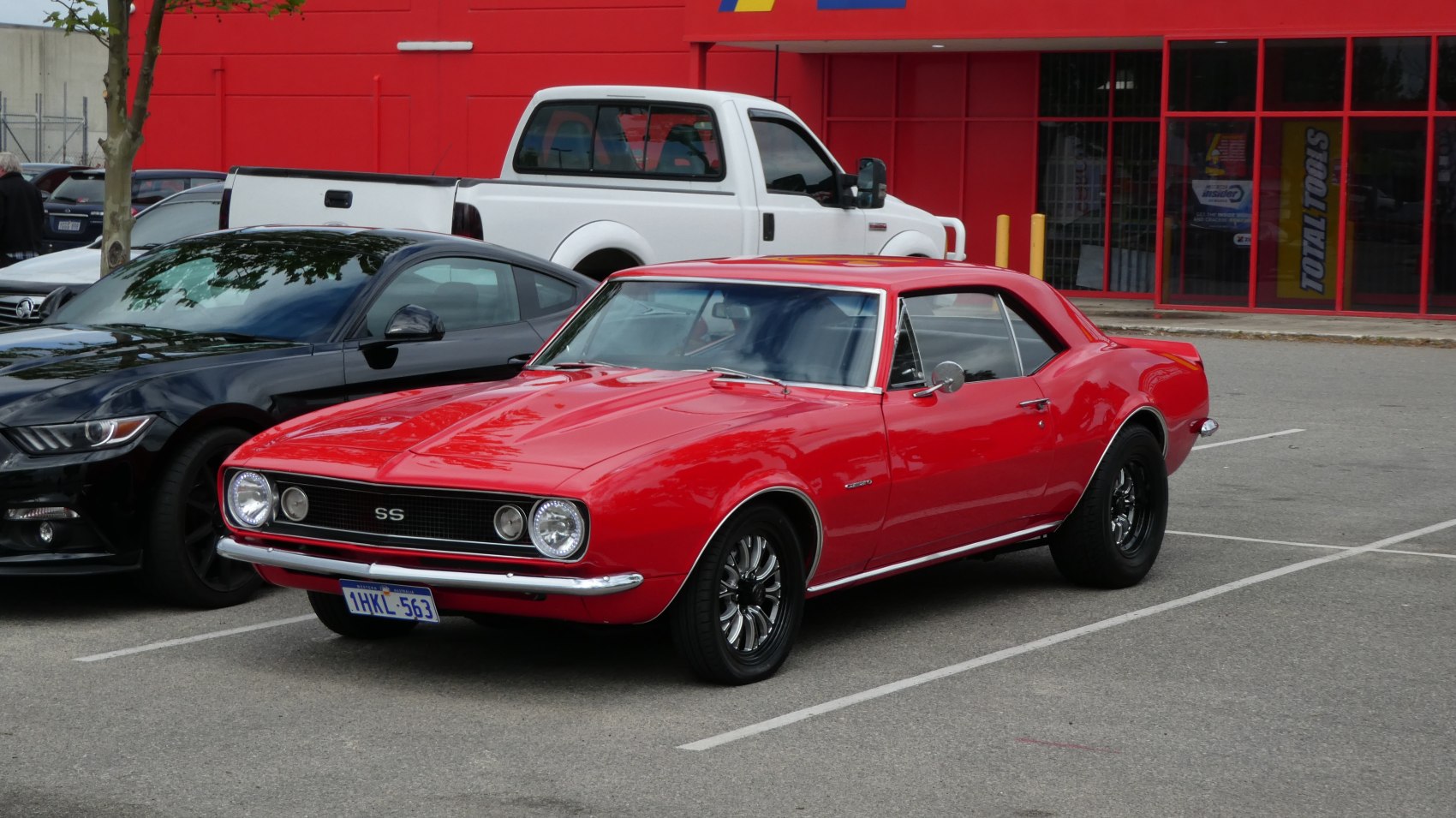 Red classic muscle coupe with SS grille and vintage wheels