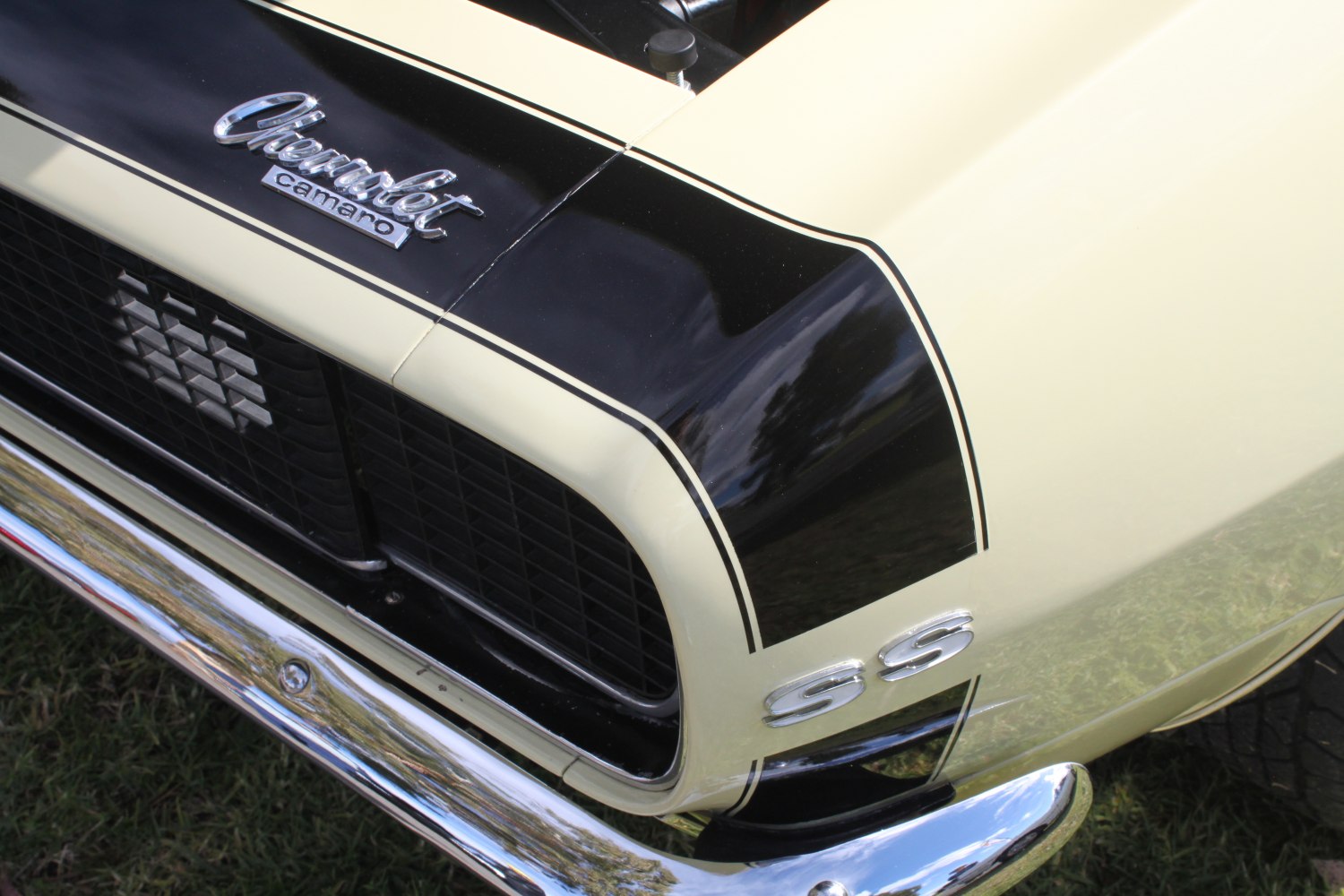 Close-up of muscle car front grille, SS badge, and hood stripes