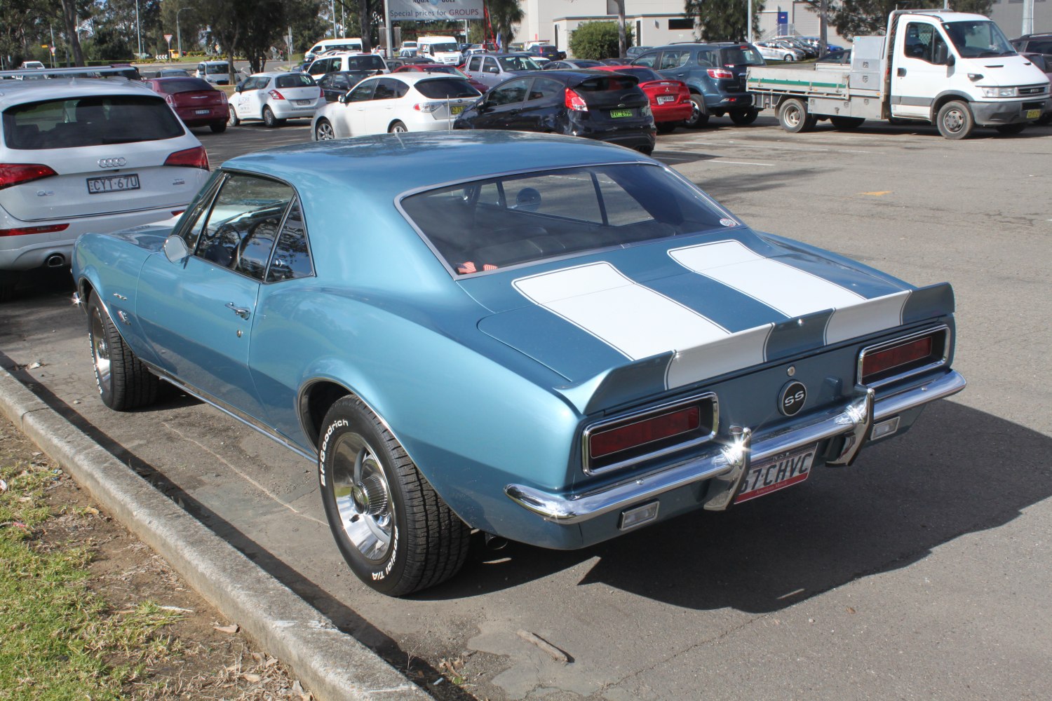 Rear view of classic muscle coupe with racing stripes and SS badge
