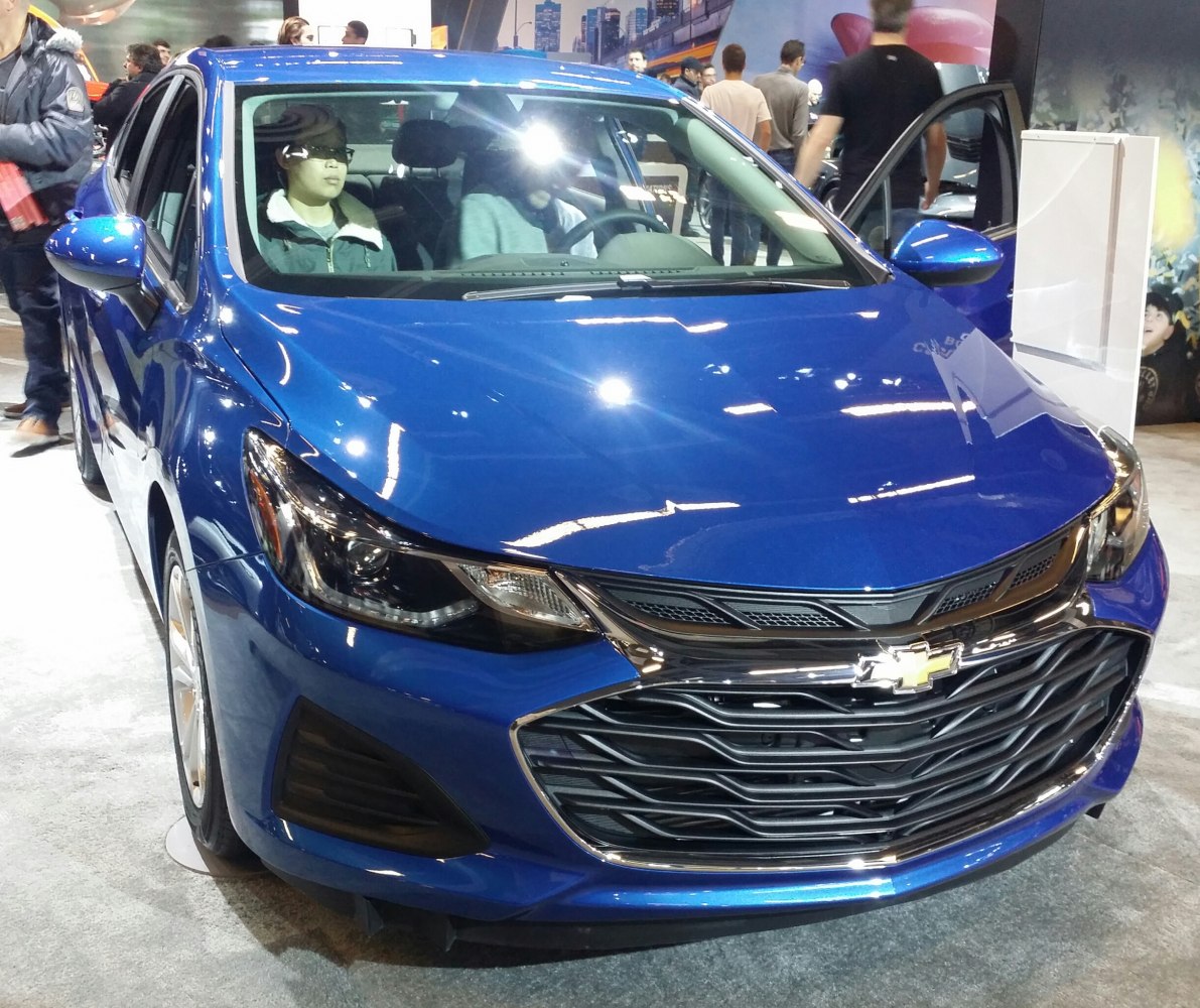Front grille and headlights of a blue modern sedan