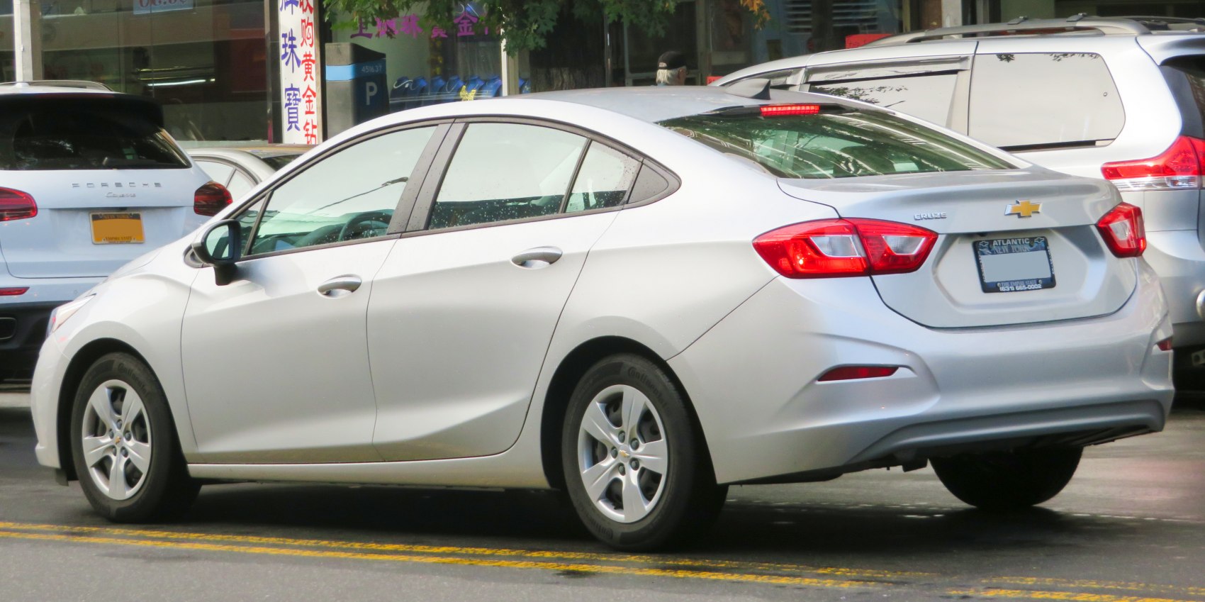 Rear side view of a mid-size sedan with alloy wheels and taillights