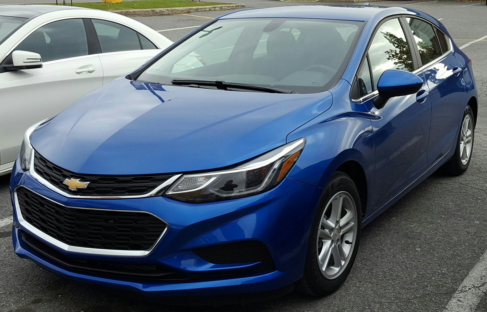 Front and side view of a blue hatchback with modern headlights