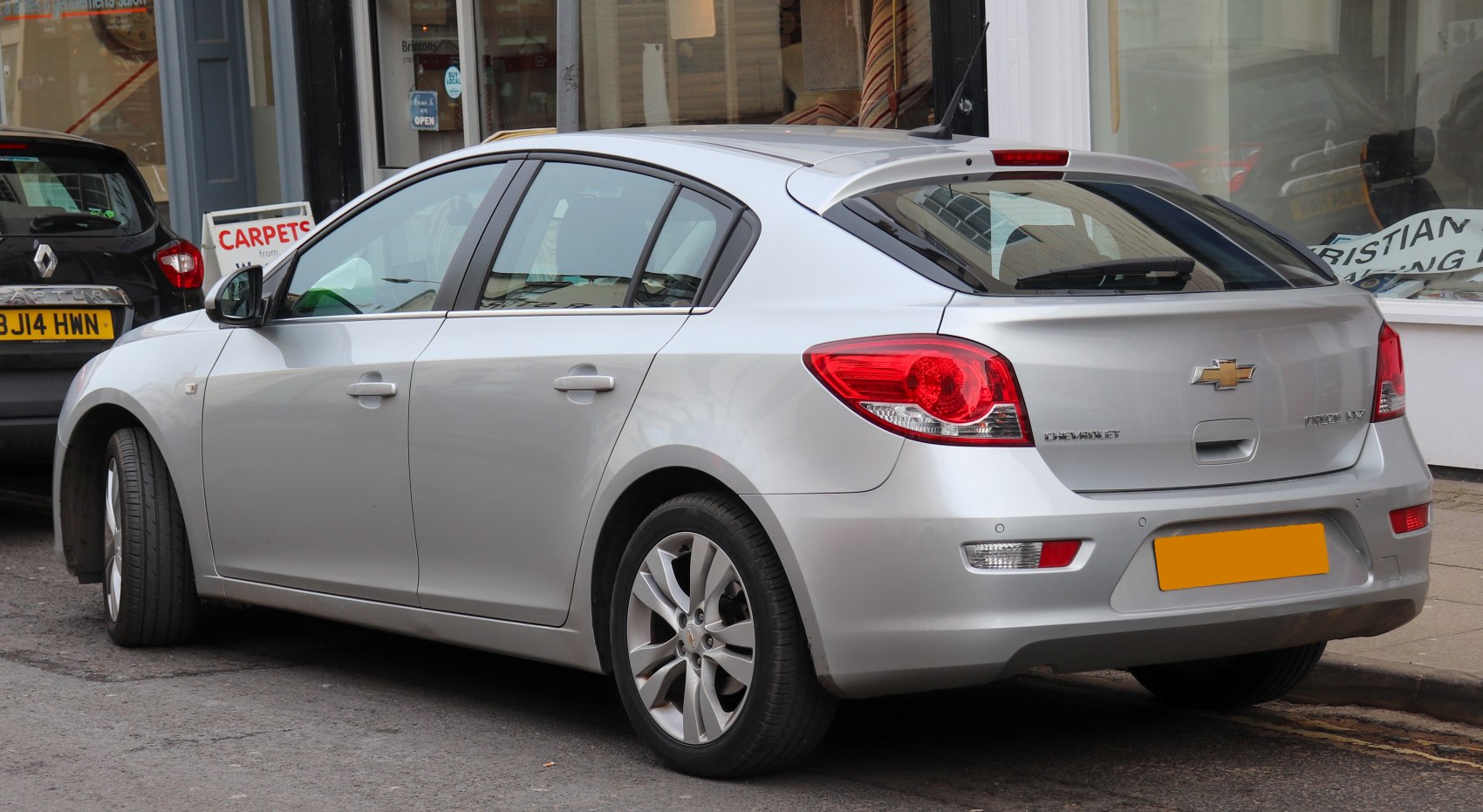 Rear-side view of silver hatchback with alloy wheels and modern taillights