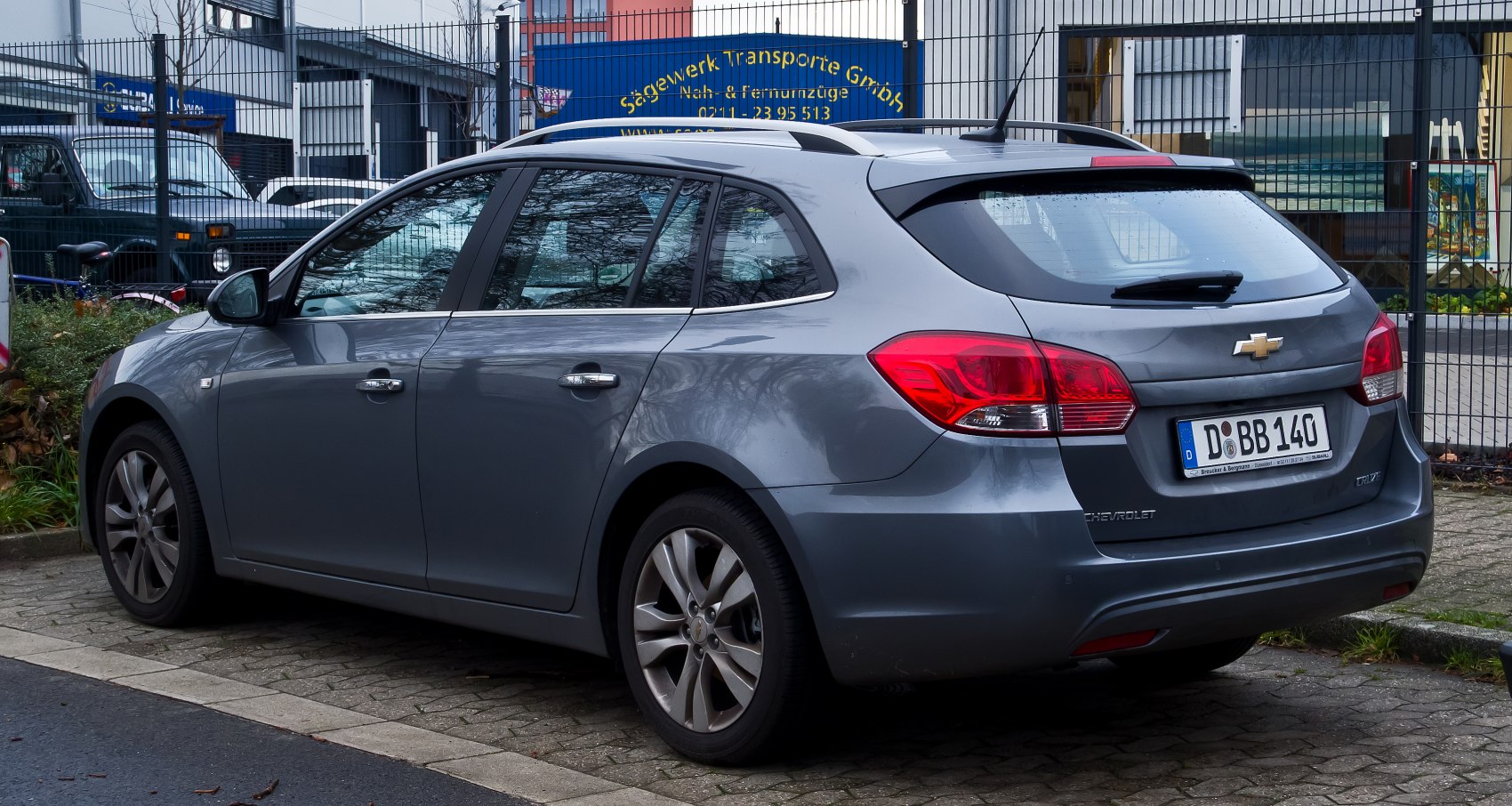 Rear and side view of a modern station wagon with tail lights and alloy wheels