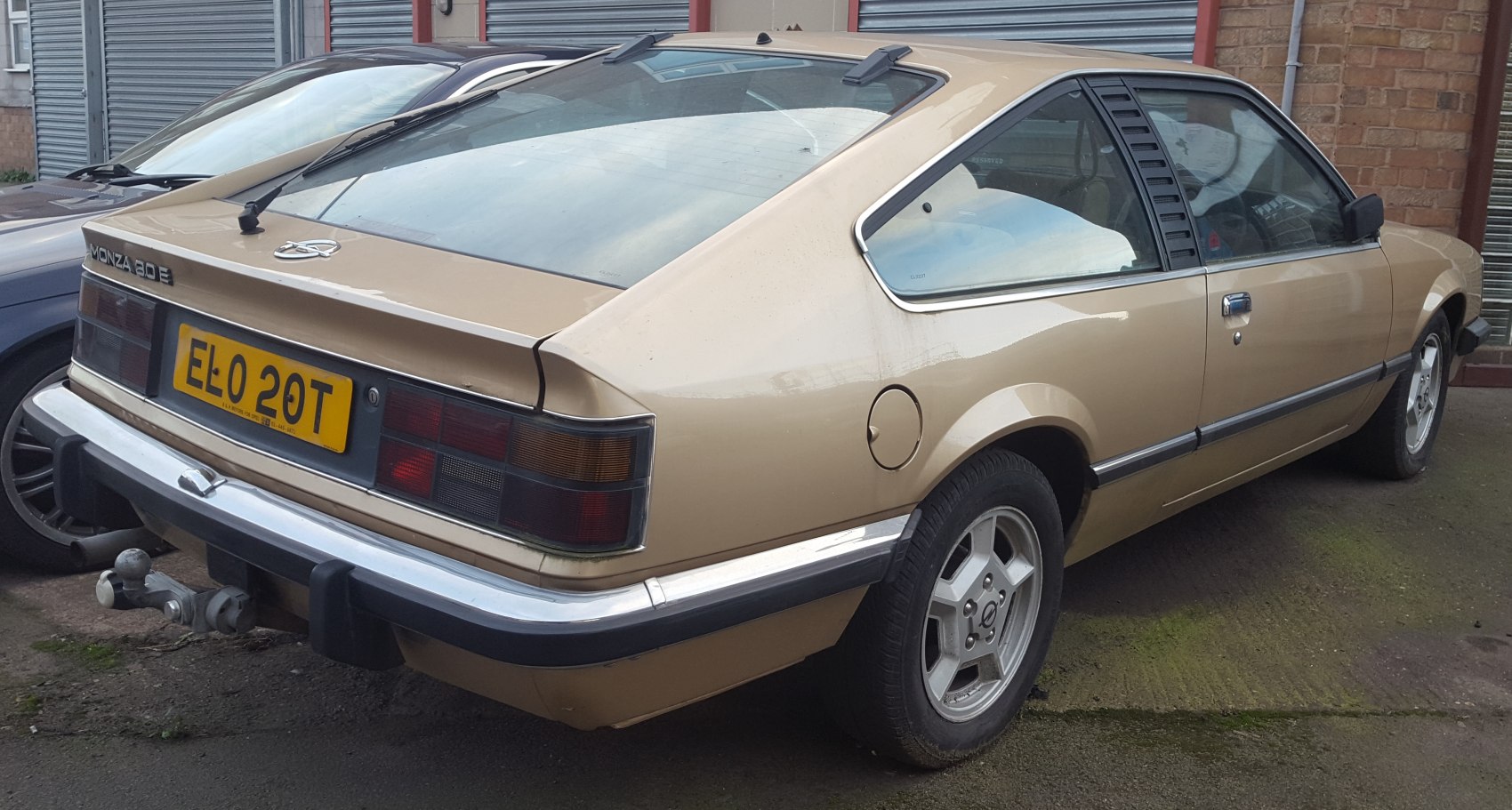 Retro hatchback rear with alloy wheels and distinctive taillights