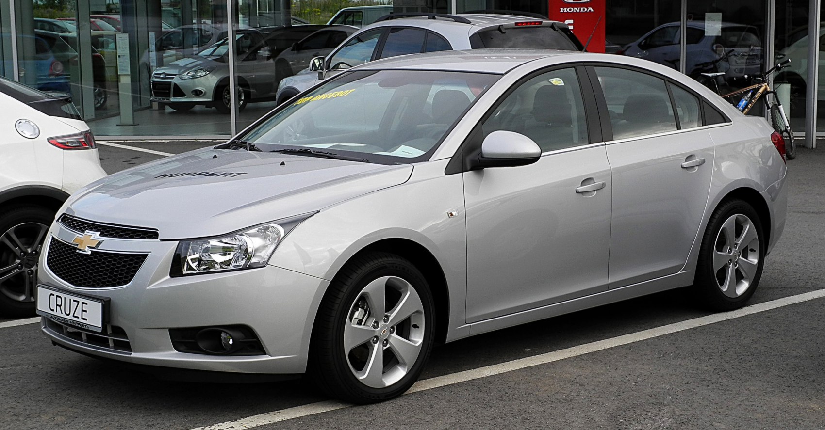 Sleek front side view of a compact sedan with alloy wheels.