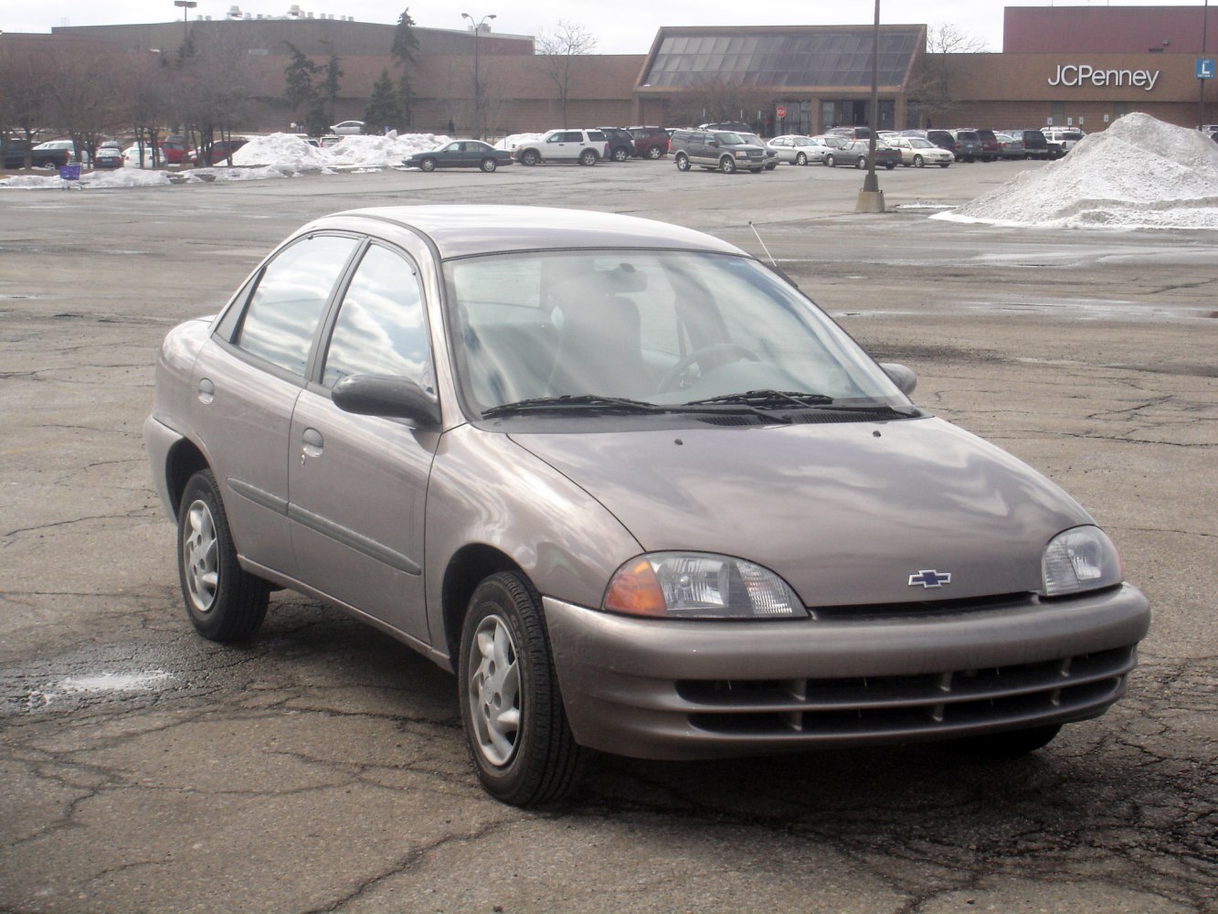 Front and side view of a compact sedan with rounded headlights and smooth body lines