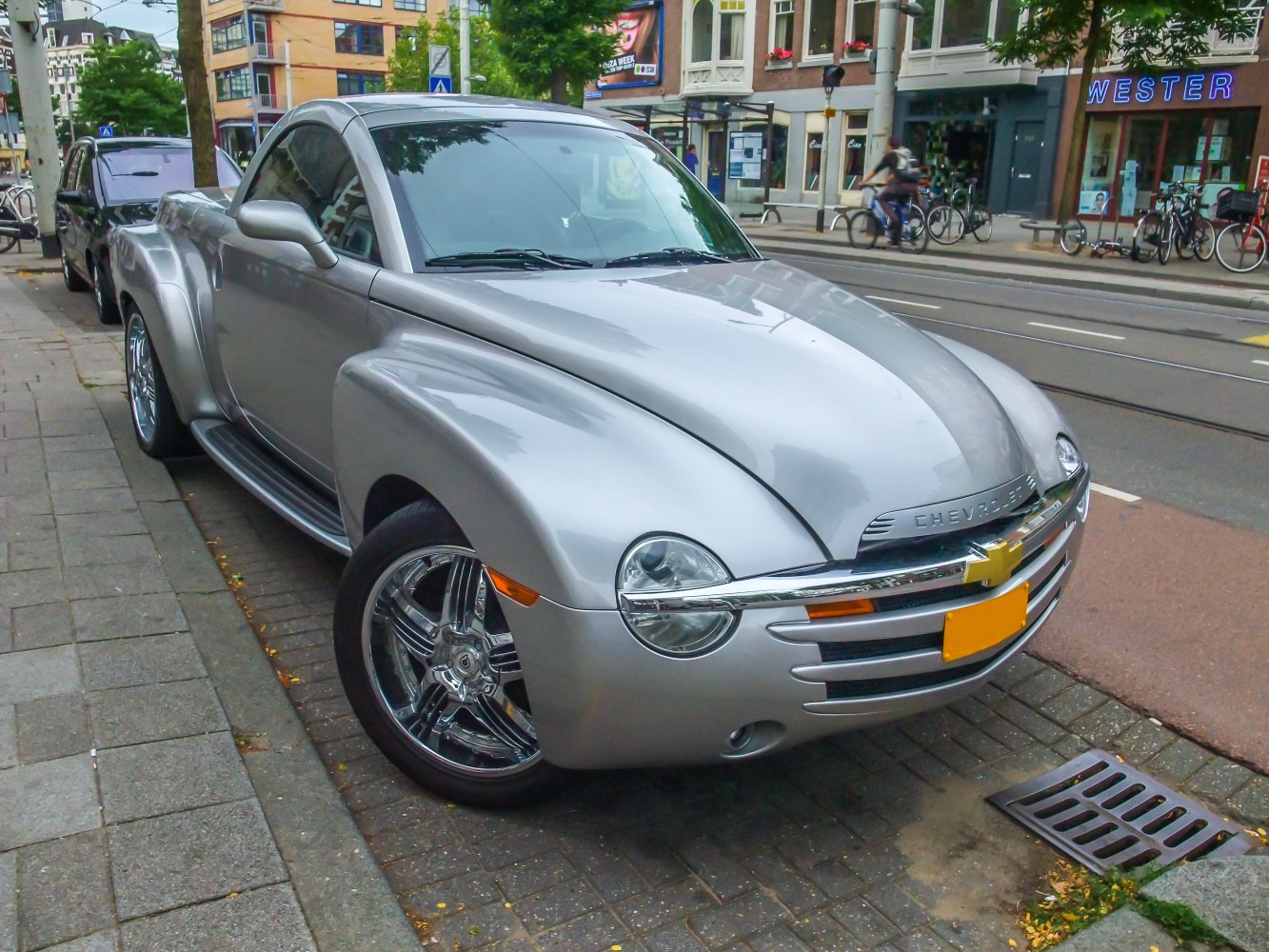 Rounded retro silver pickup with chrome wheels and distinctive front grille
