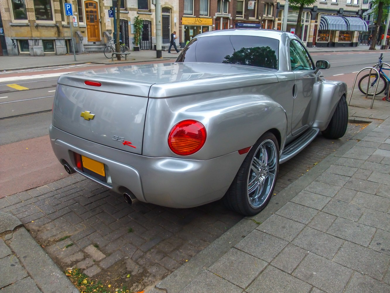 Rounded taillights and covered pickup bed rear view.
