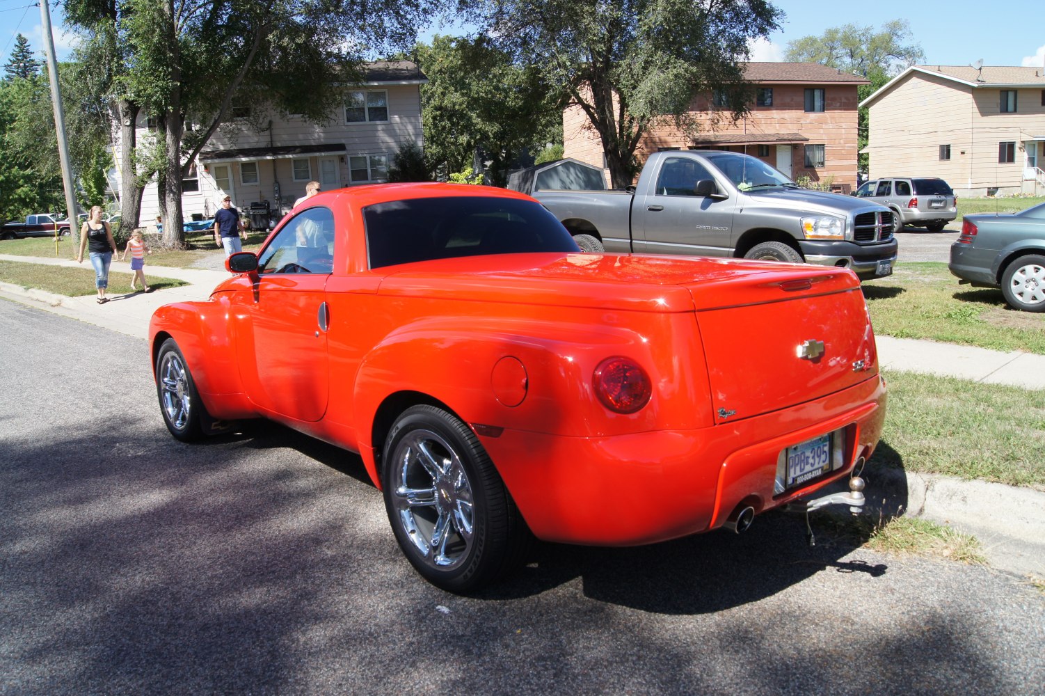 Bright red retro-style pickup rear quarter with rounded tail light and smooth truck bed cover