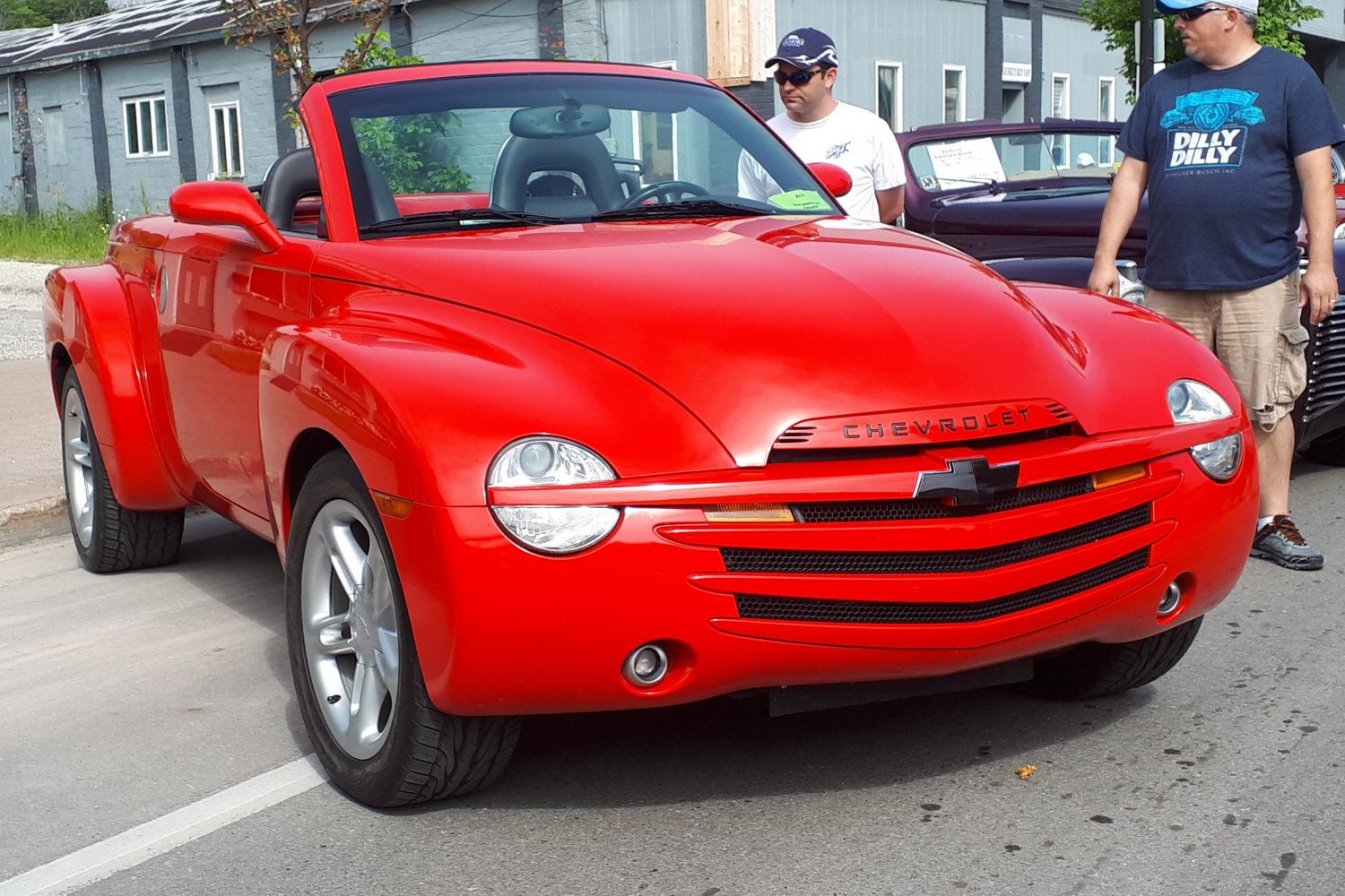 Red retro convertible pickup front view with bold grille and rounded headlights