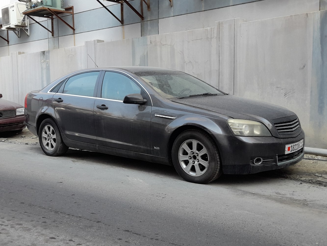 Black sedan with distinctive front grille and alloy wheels