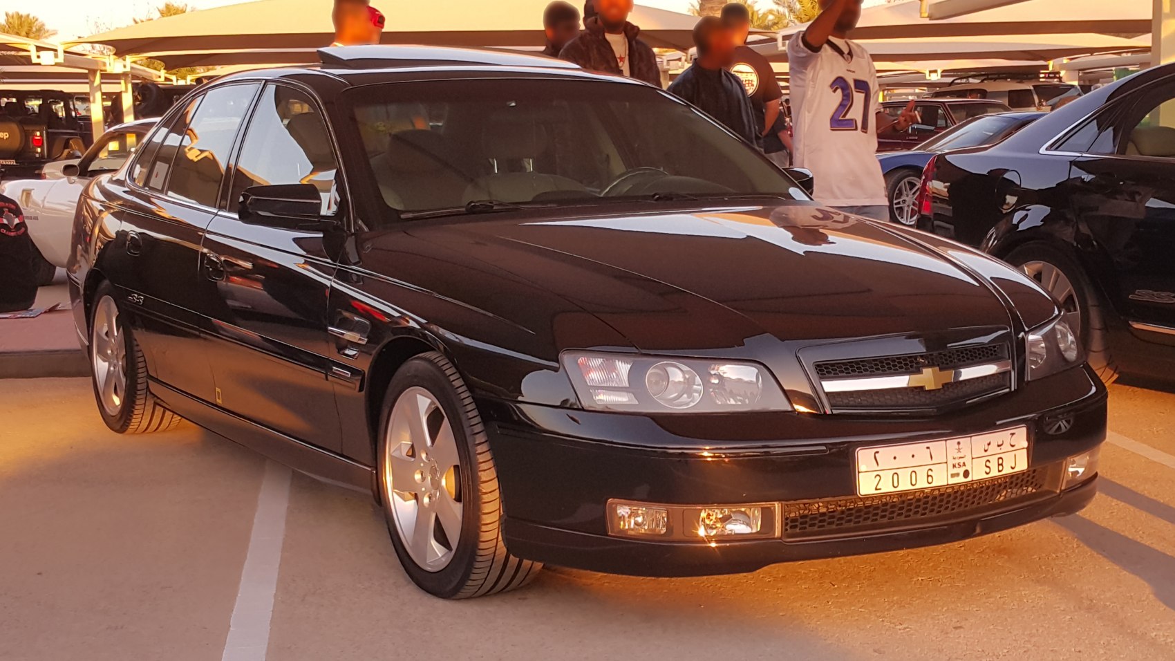 Black sedan with distinct front and side profile, alloy wheels
