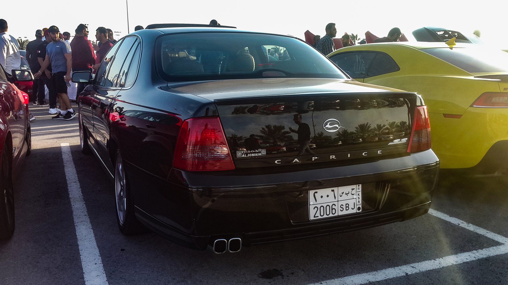 Rear view of black sedan with distinctive taillights and SS quad exhaust
