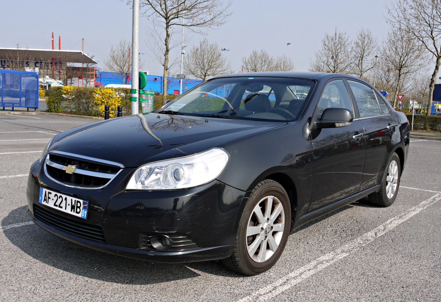 Front-left view of a black sedan with headlights and alloy wheels