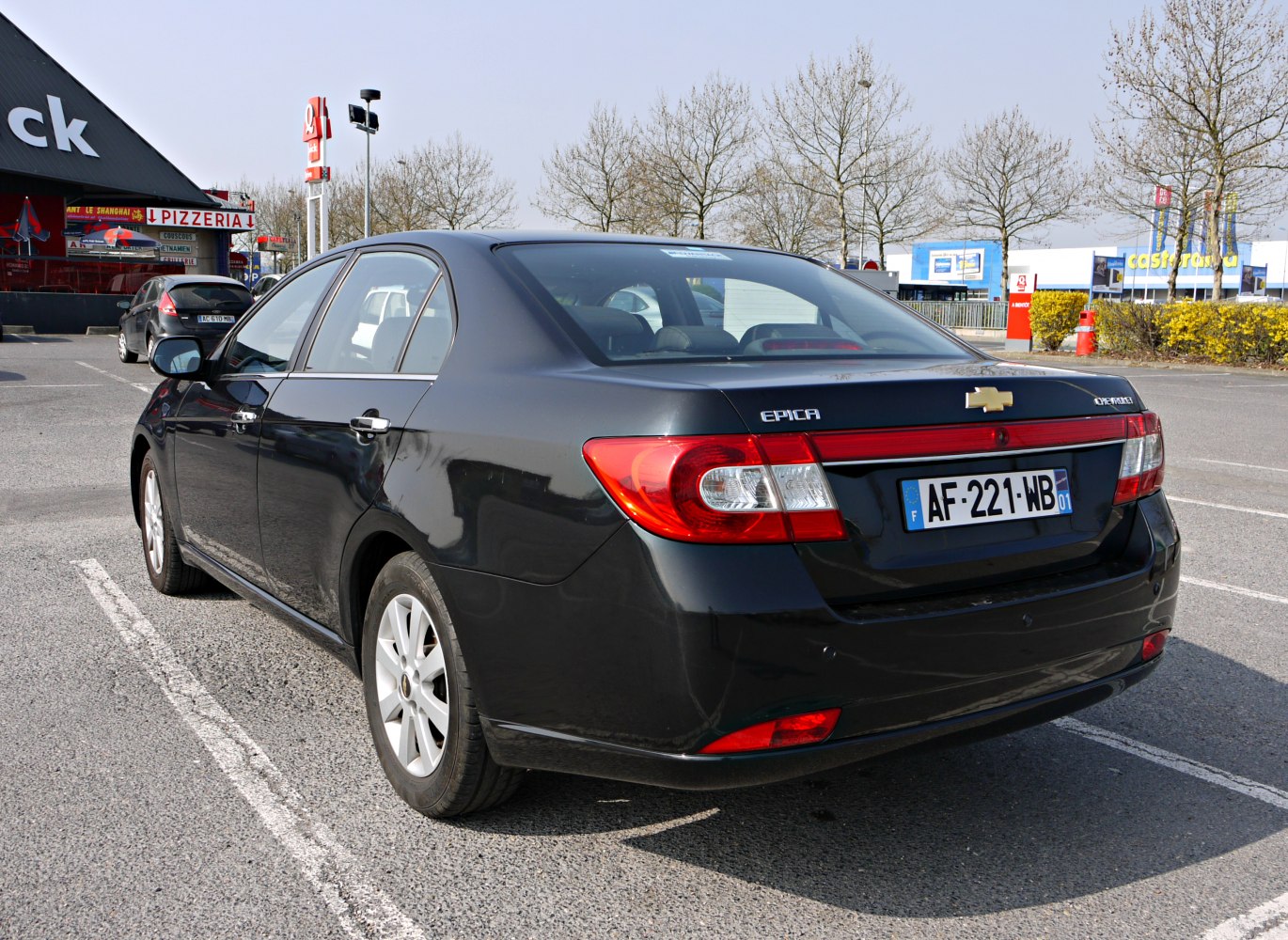 Rear view of sedan with distinctive tail lights and structured rear design