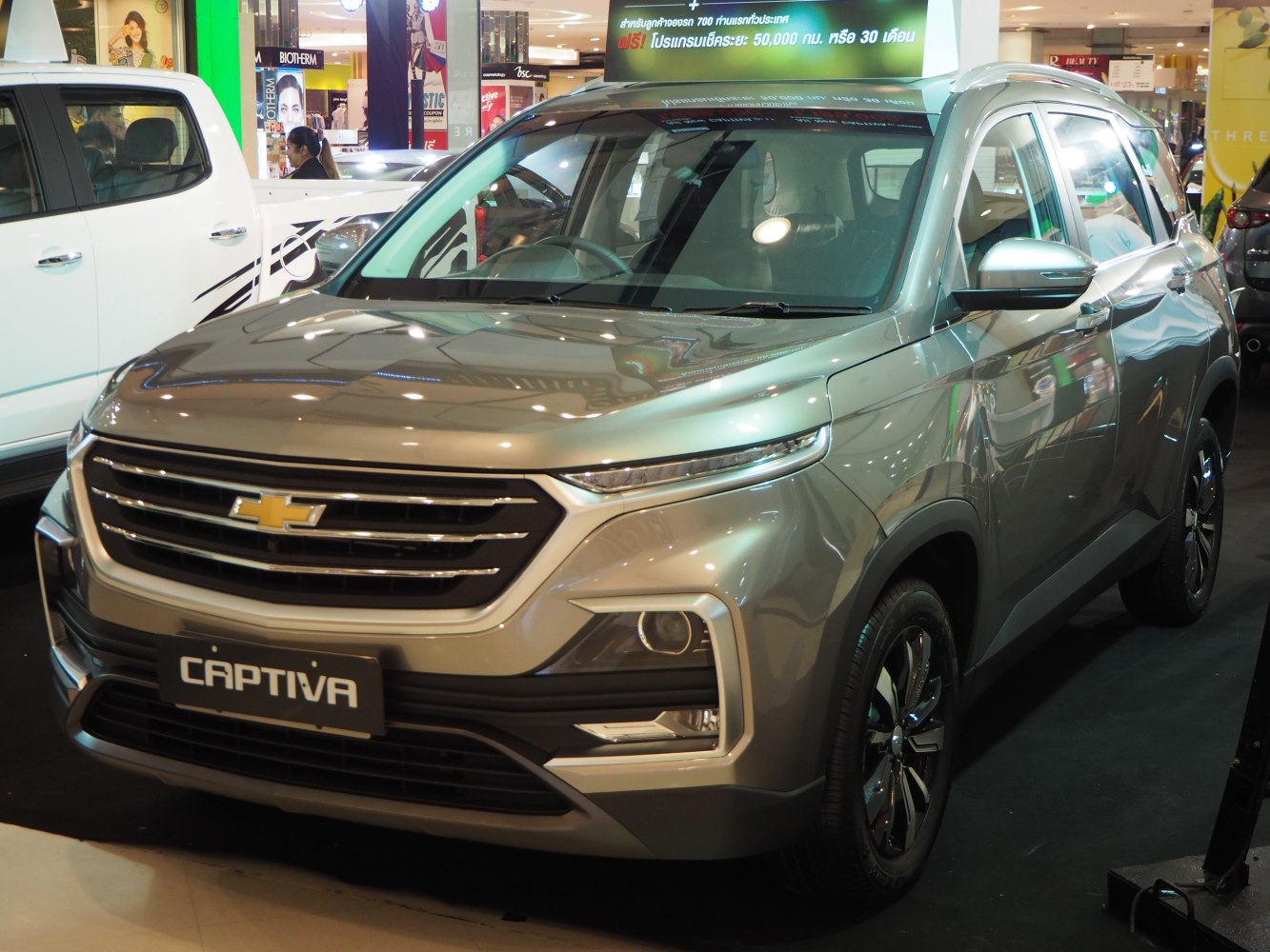 Front grille and LED headlights of modern SUV in showroom