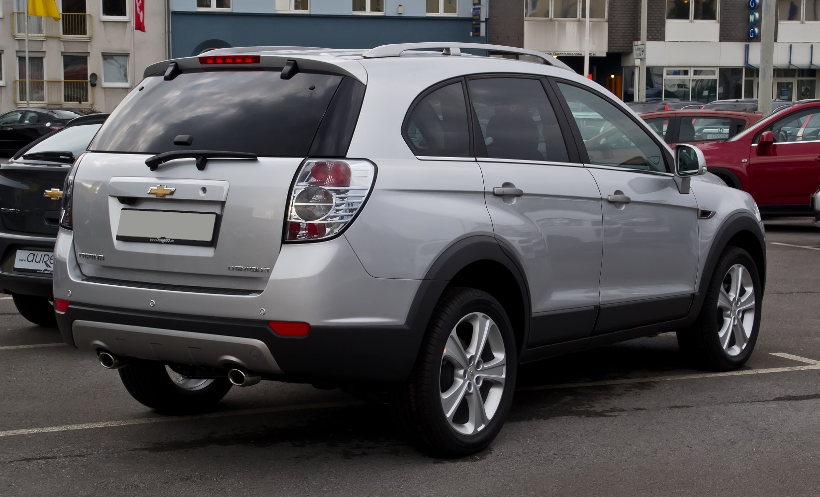 Silver SUV rear and side with dual exhausts and roof rails