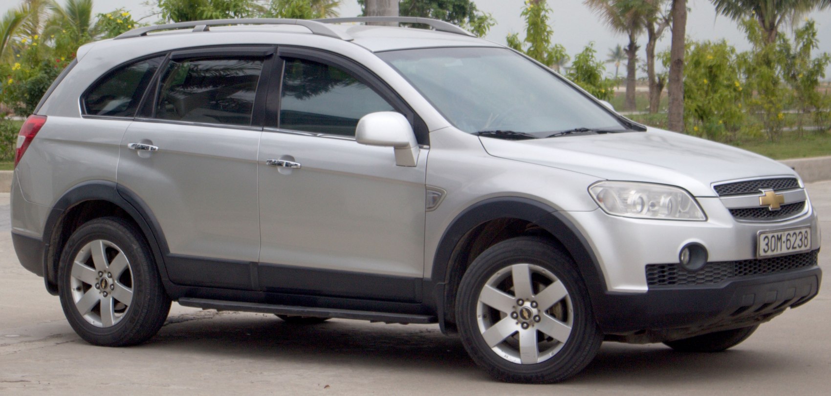 Silver midsize SUV side view with rugged tires and roof rails