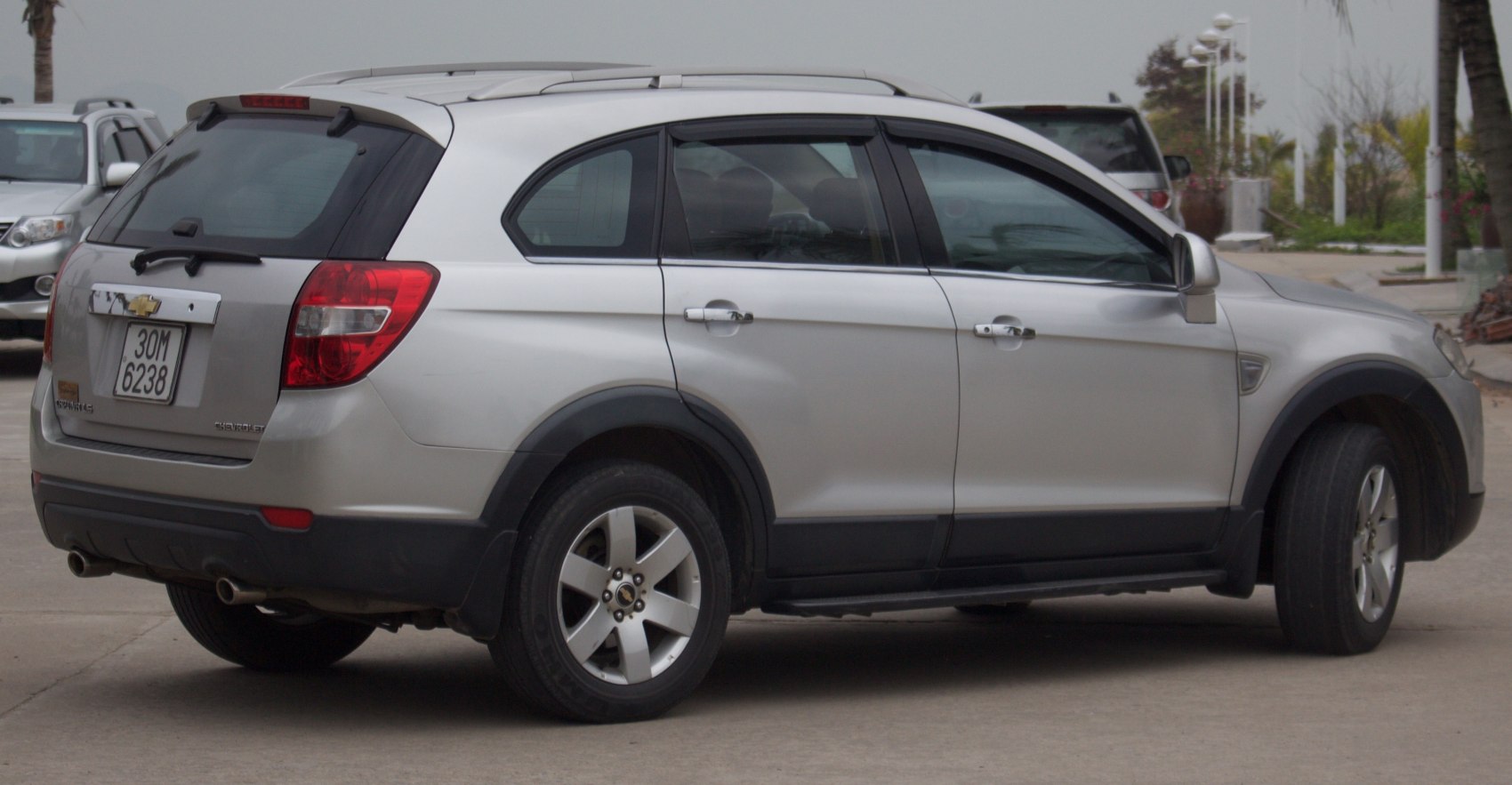 Silver SUV side rear view with alloy wheels and dual exhaust