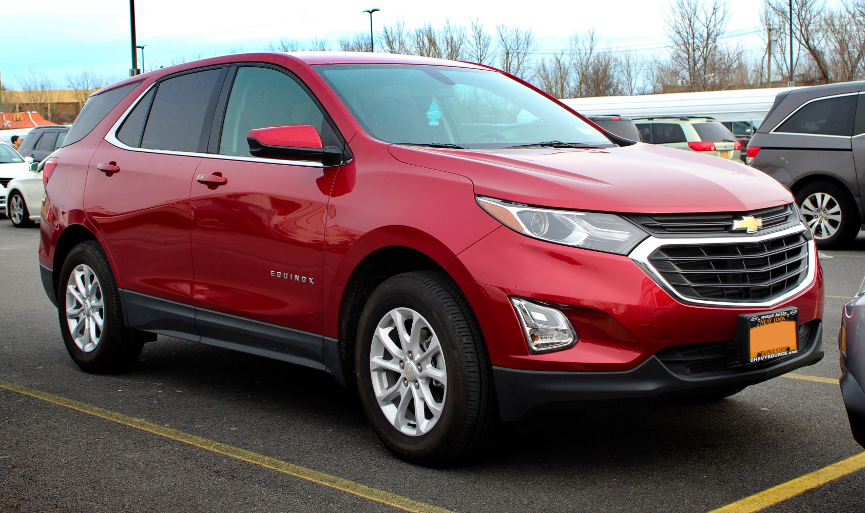 Red SUV with bold front grille and alloy wheels