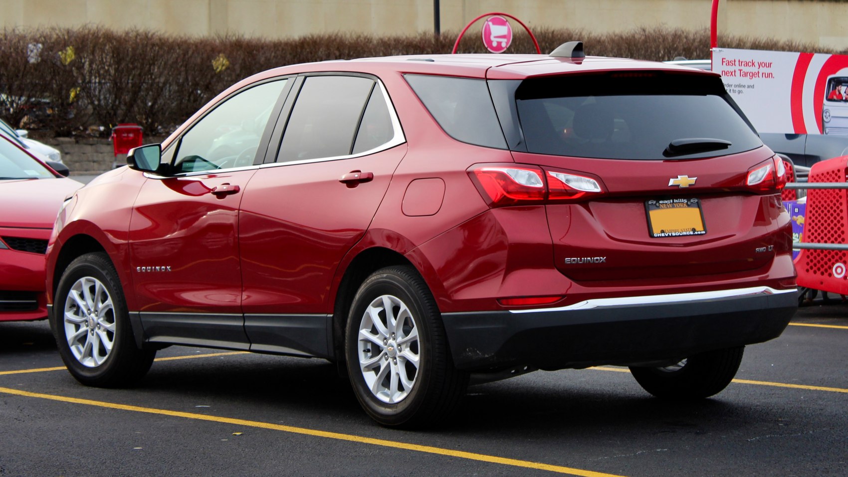Red SUV rear and side view with alloy wheels and rear lights