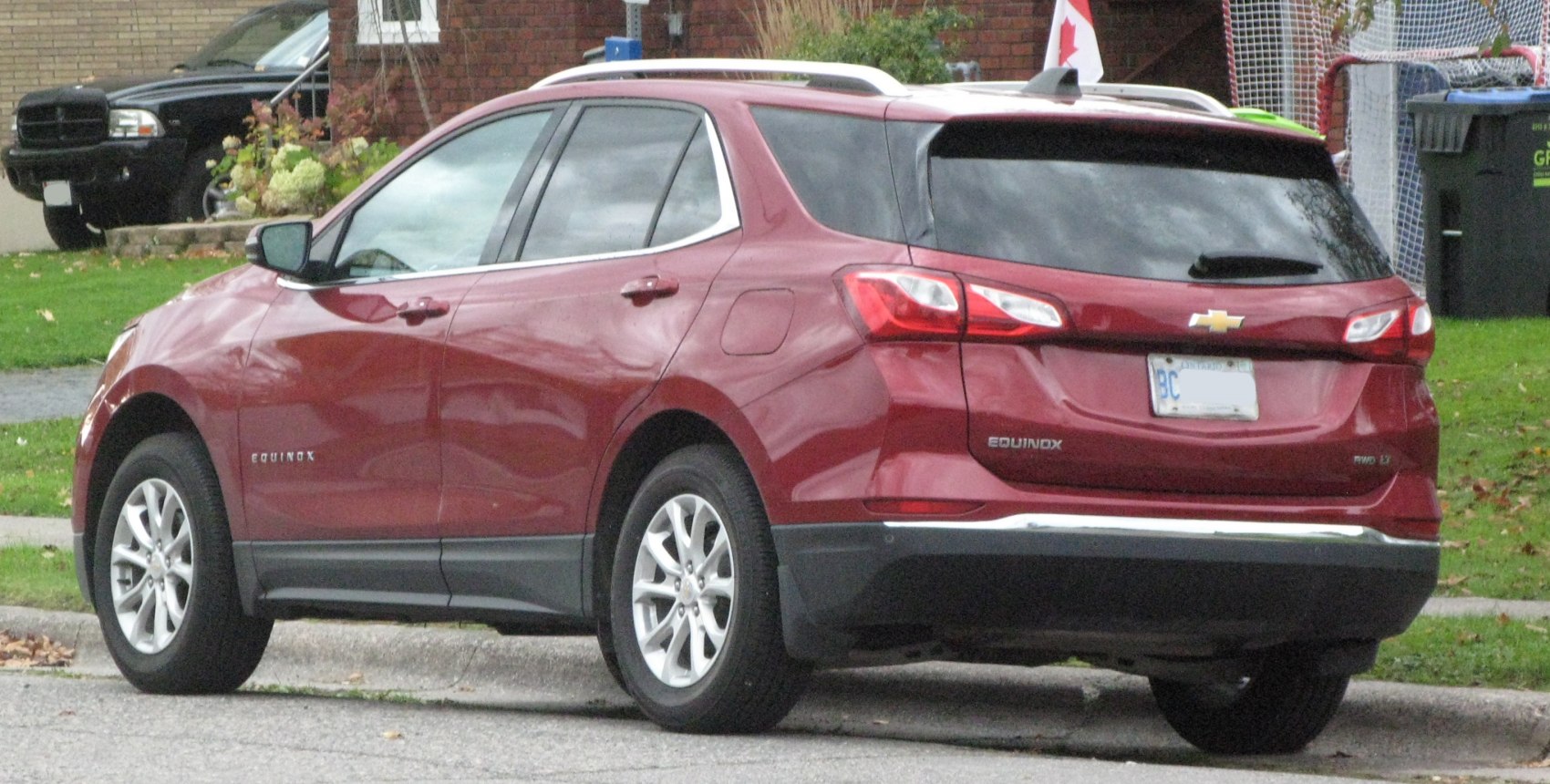 Rear side view of a mid-size SUV with sleek styling and tinted windows