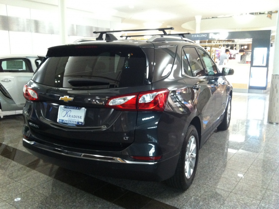 Rear view of black mid-size SUV with distinct taillights and LT trim badge