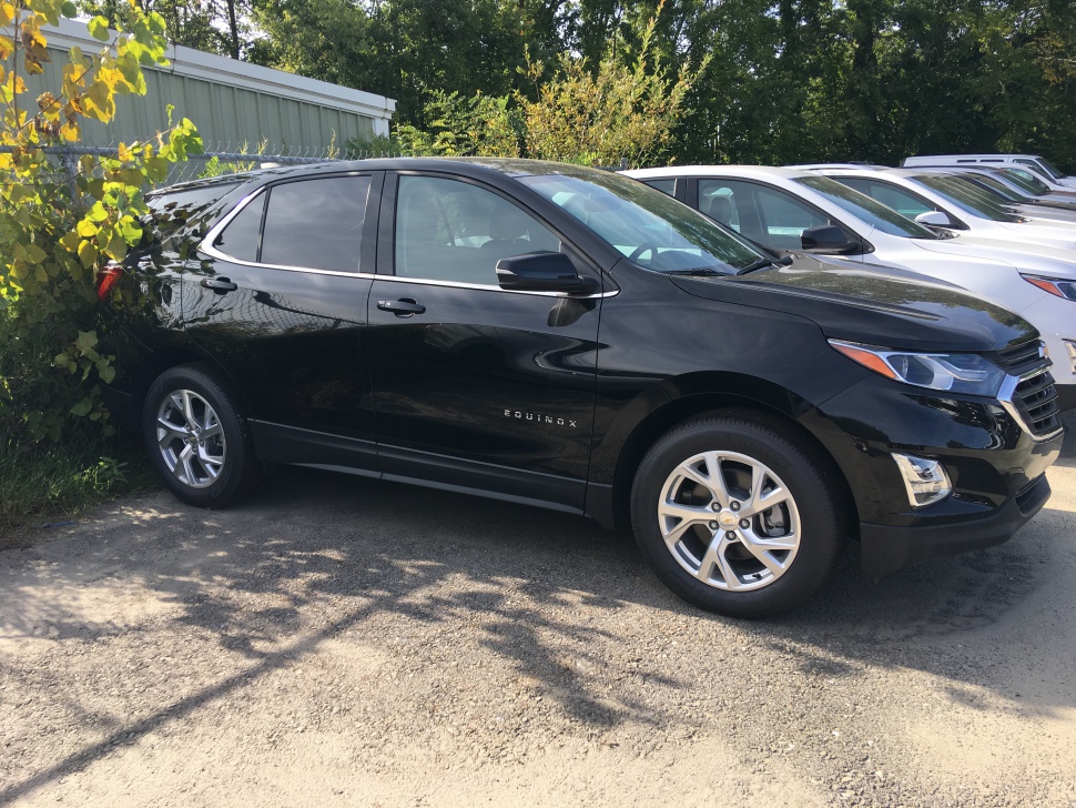 Side profile of black mid-size SUV with alloy wheels and tinted windows