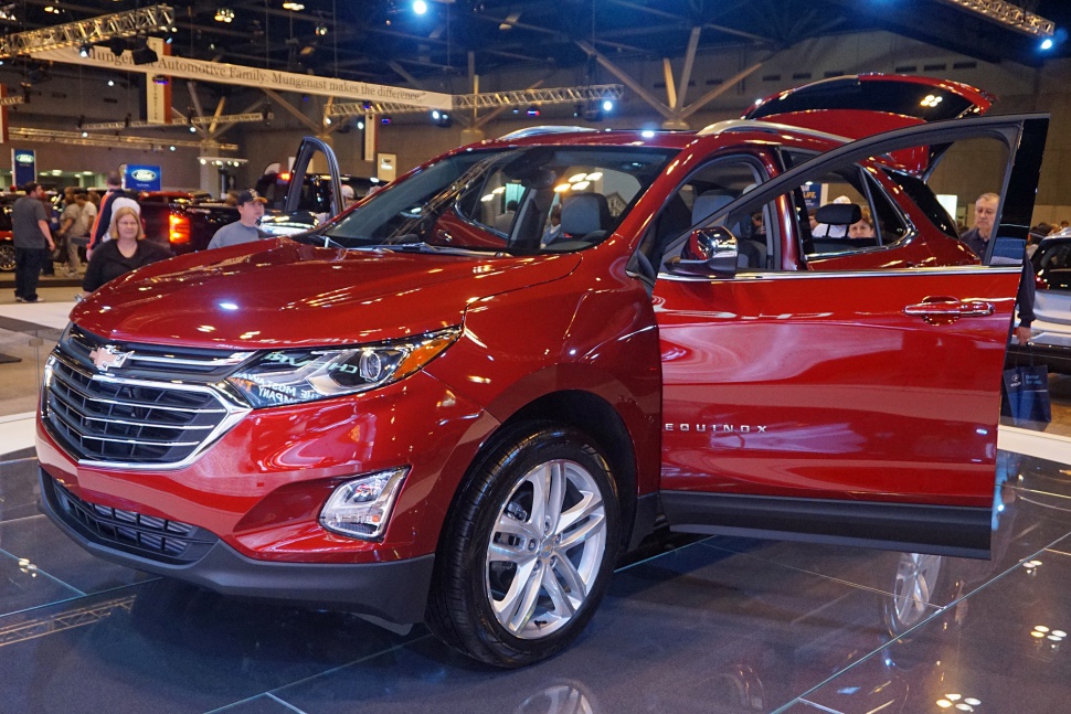 Red SUV with open doors, front-side view, wheels and headlights visible