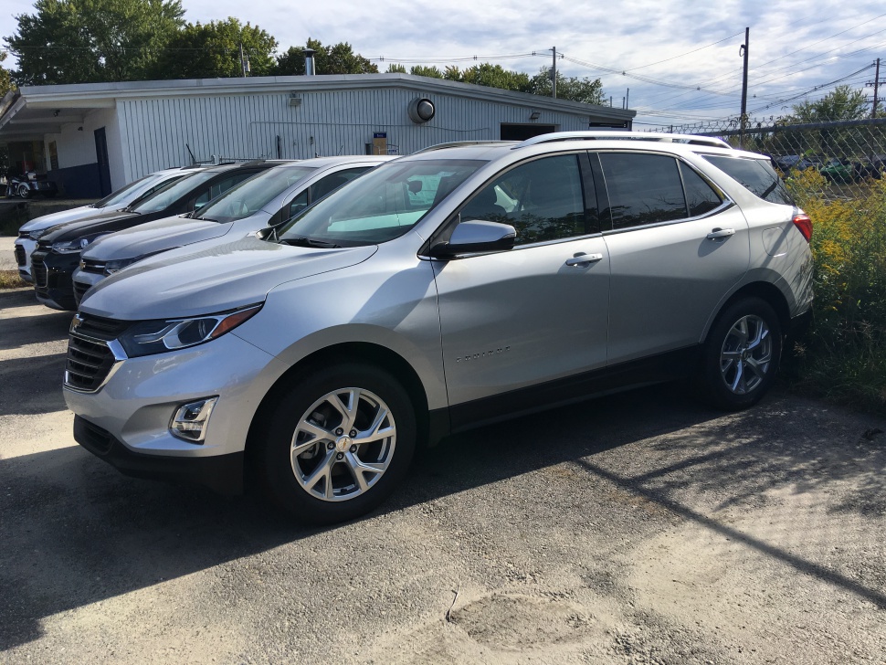 Silver SUV front side profile with alloy wheels parked outdoors