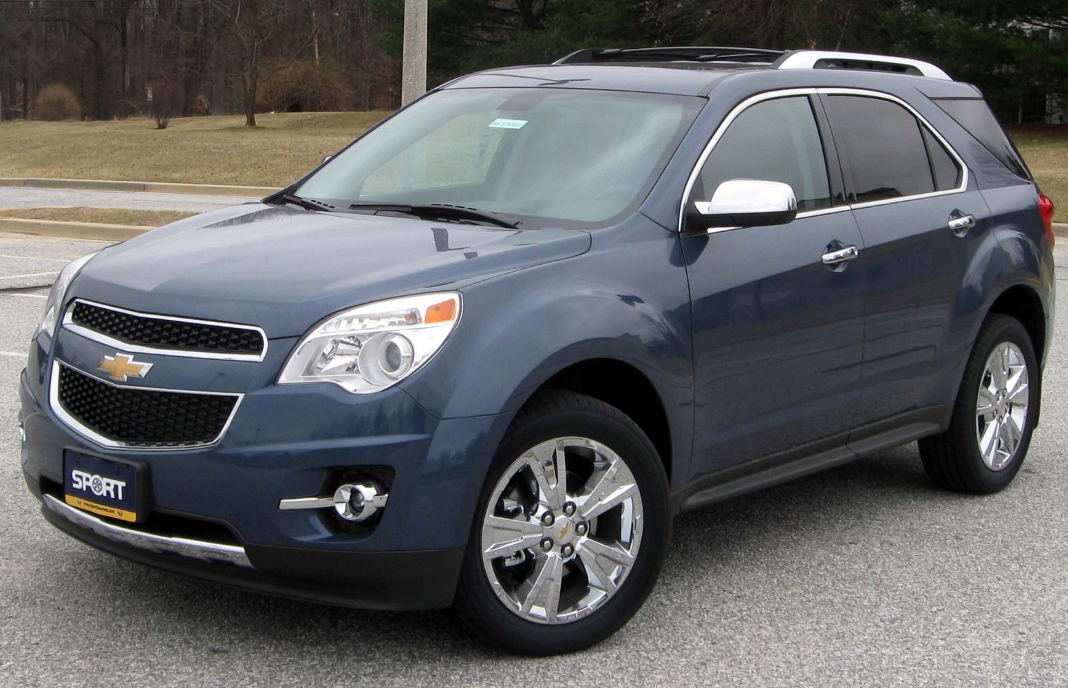 Mid-size SUV with chrome wheels and roof rack