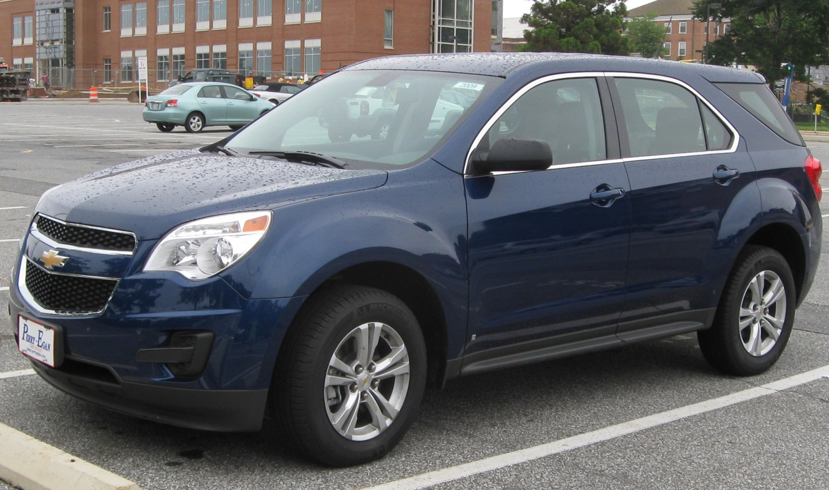 Front side view of a blue midsize SUV with alloy wheels