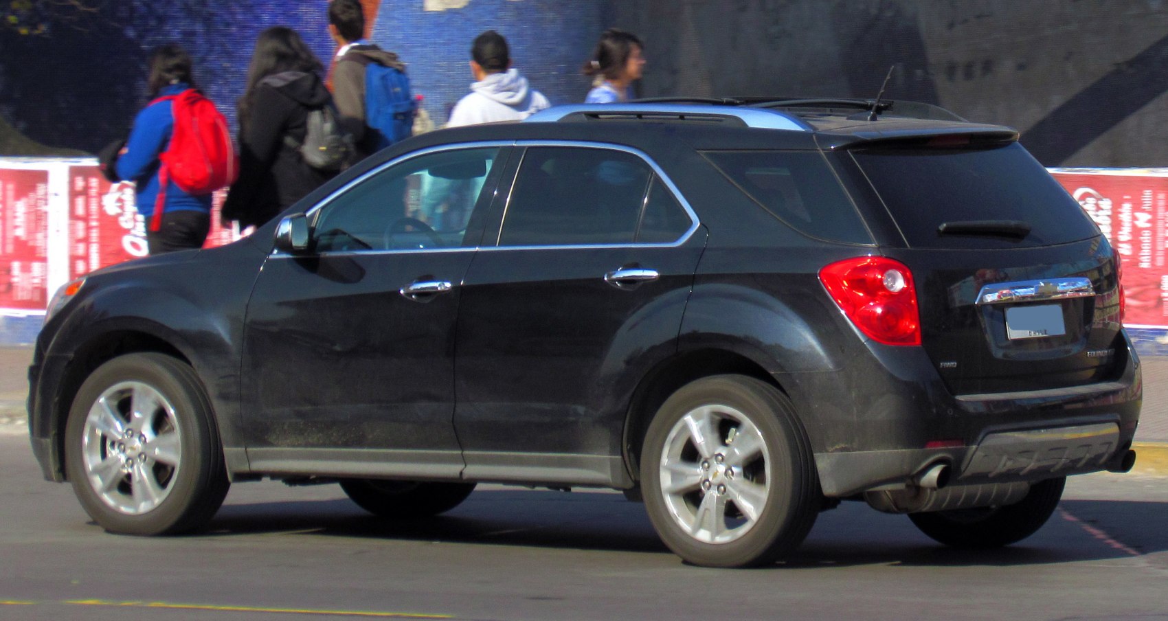 Black SUV side and rear view with roof rails and alloy wheels